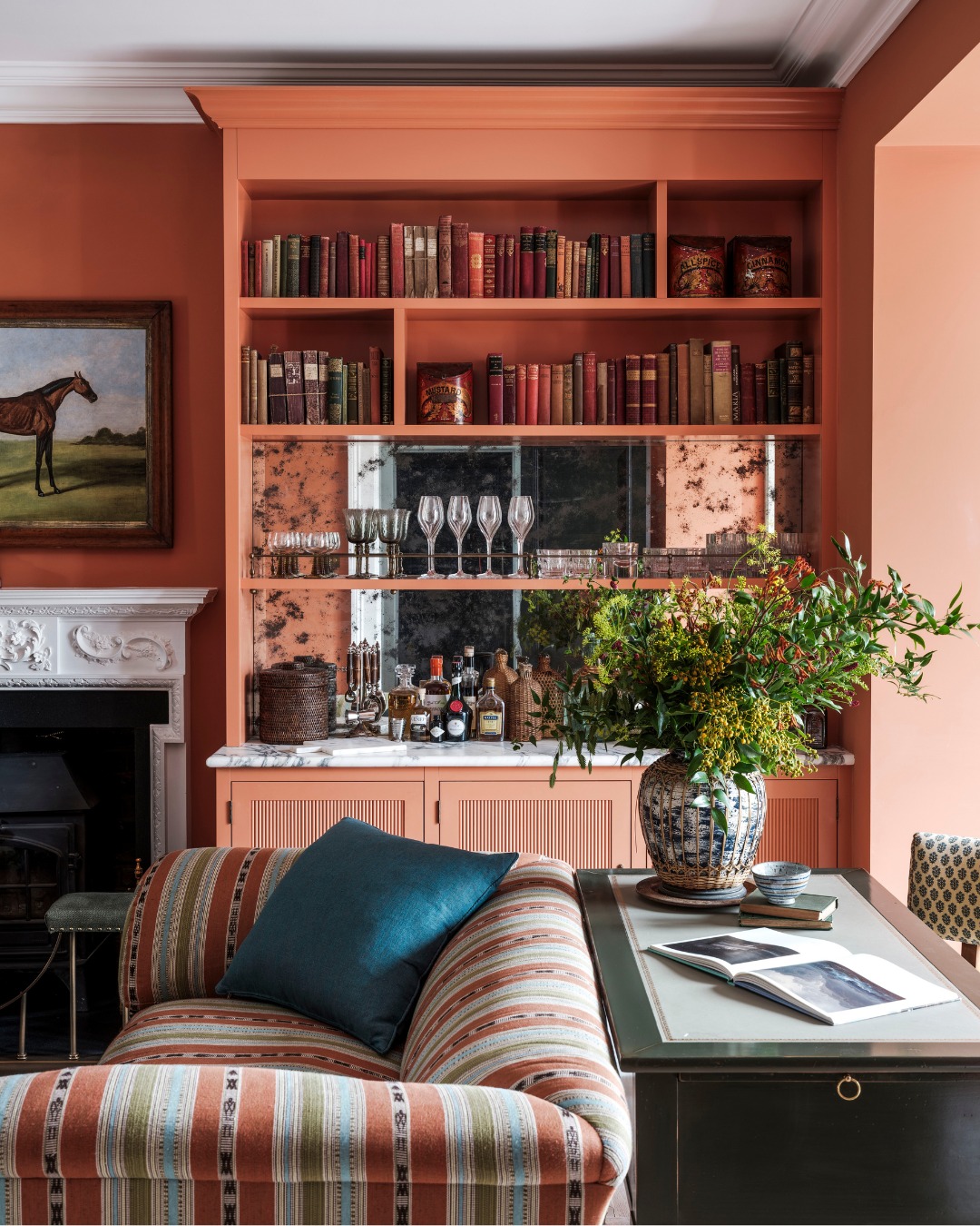15. Warm a Reading Corner With Coral Shelves