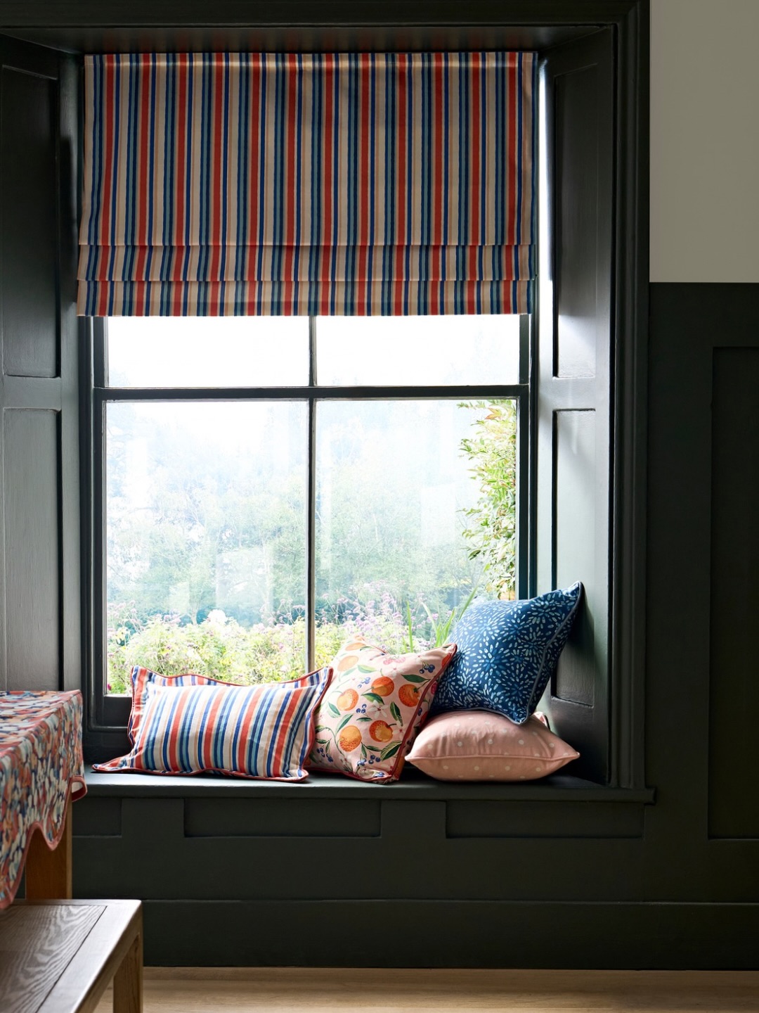 12. Brighten a Dark Green Window Seat With Orange Stripes