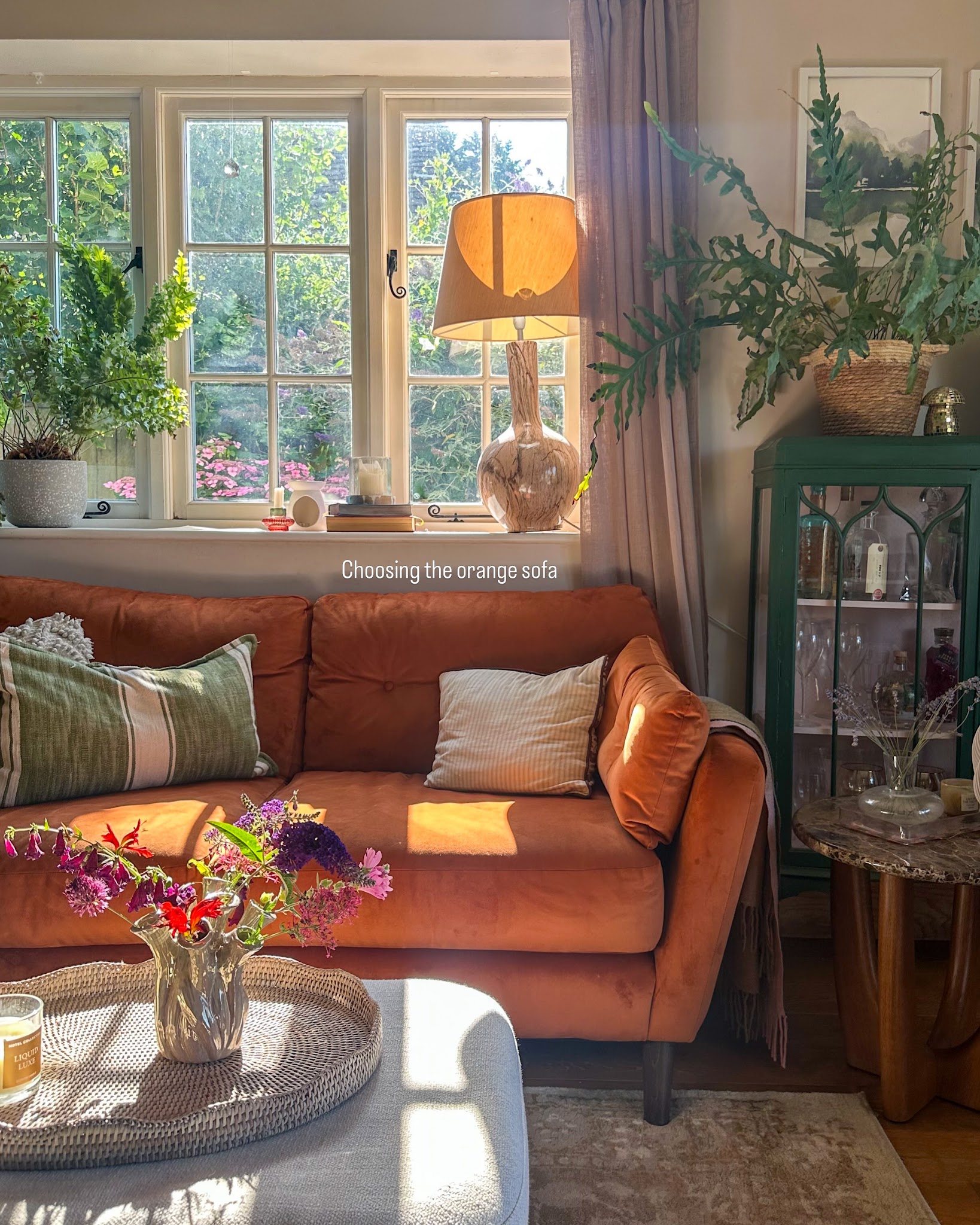 19. Pair an Orange Sofa With a Green Display Cabinet
