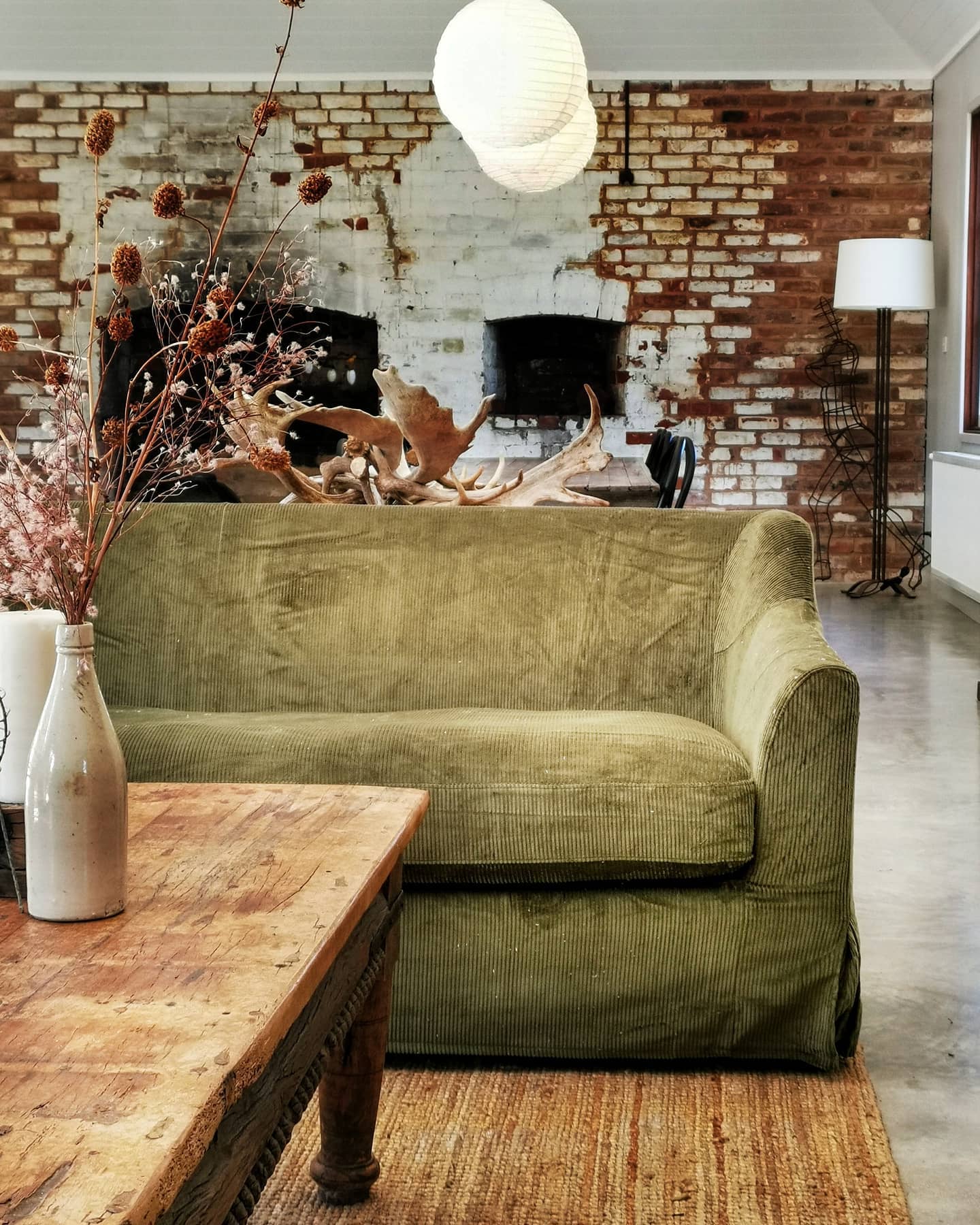 17. Pair an Olive Sofa With Exposed Brick