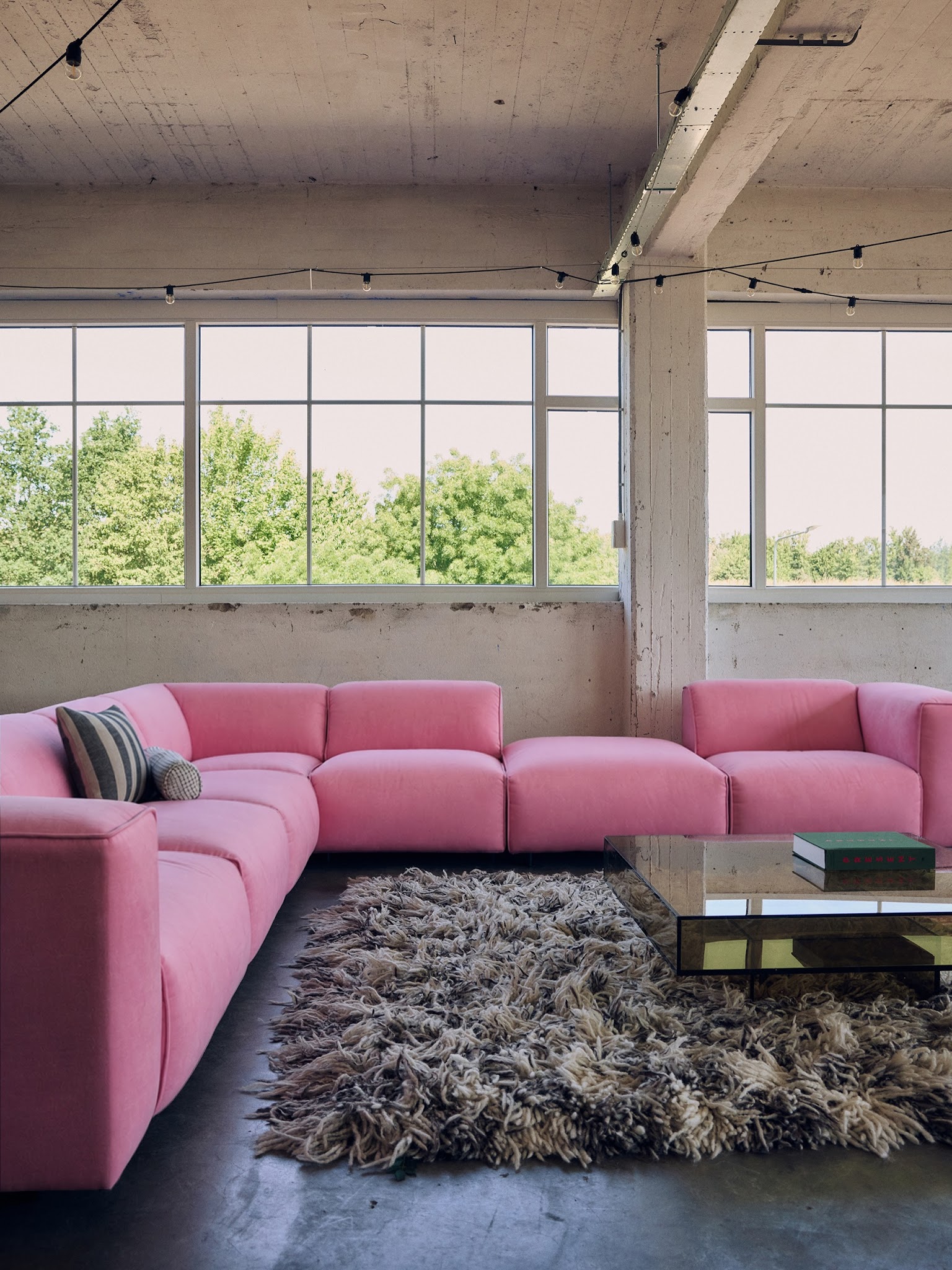 11. Soften an Industrial Gray Room With Pink Seating