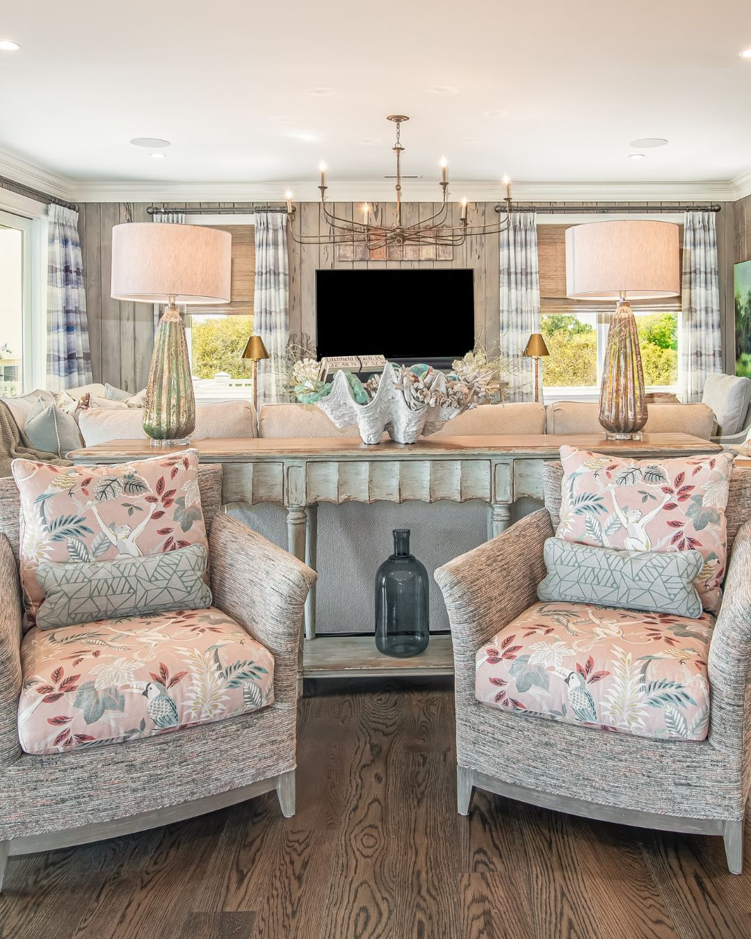 13. Combine Pink Botanical Cushions With Gray Woven Chairs