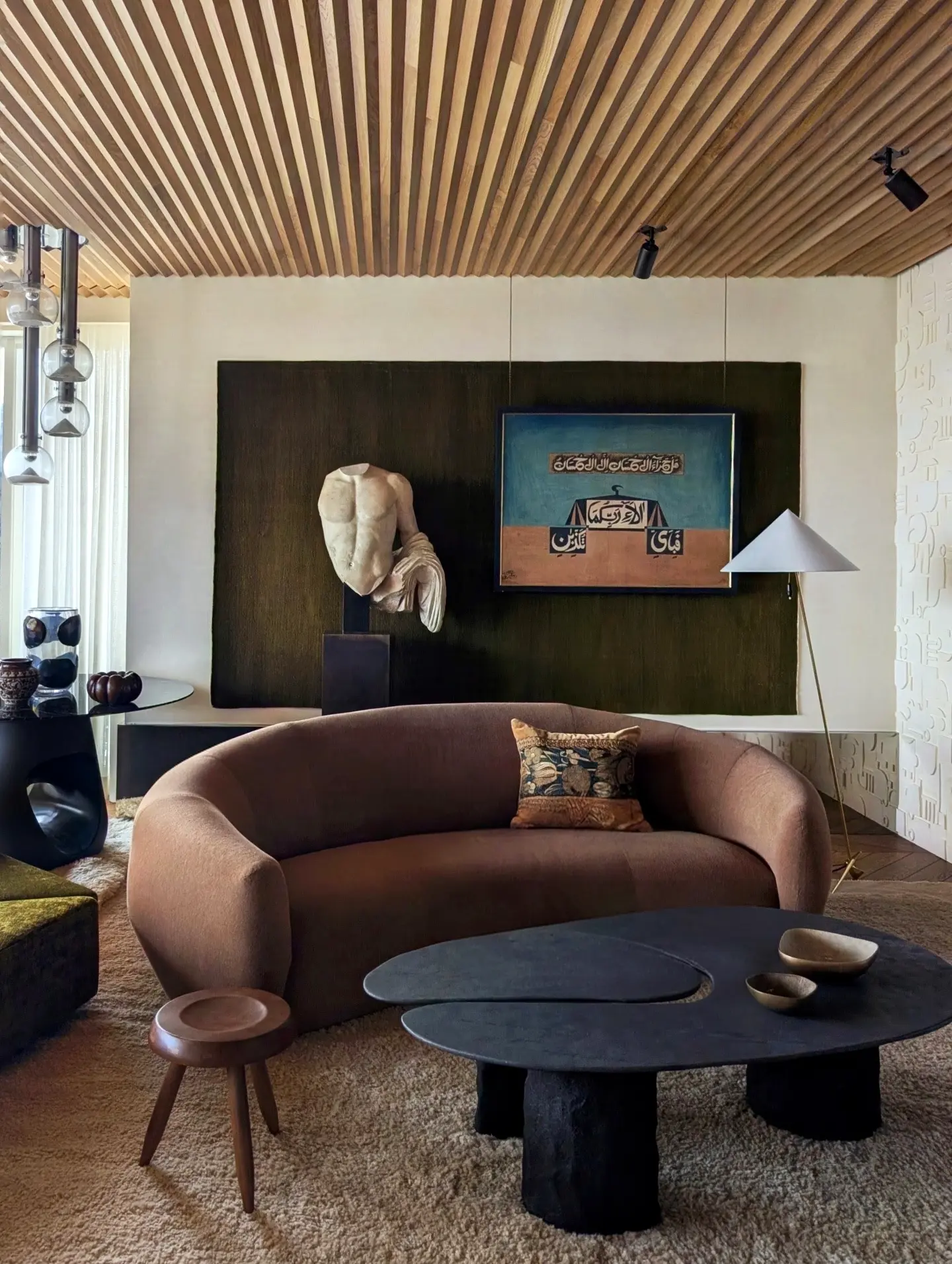 8. Set Sculptural Charcoal Tables Before a Brown Sofa