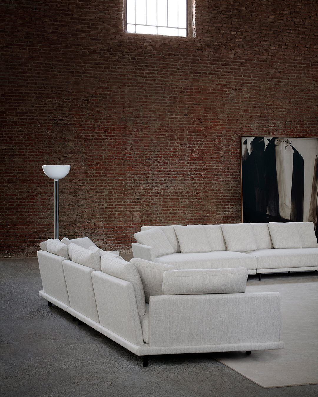 13. Let Brown Brick Warm a Pale Gray Seating Group