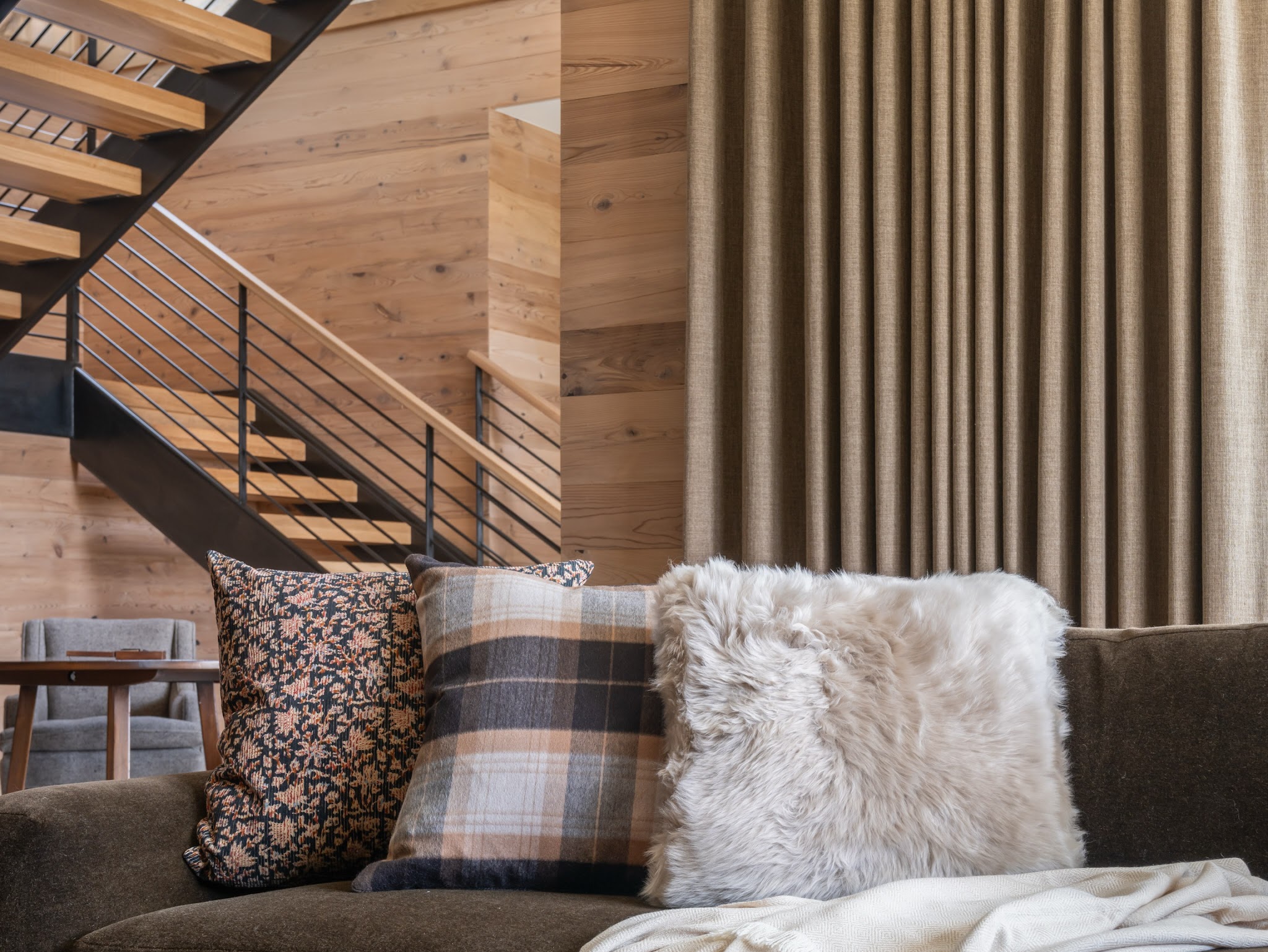 13. Soften a Steel Staircase with Layered Sofa Textiles