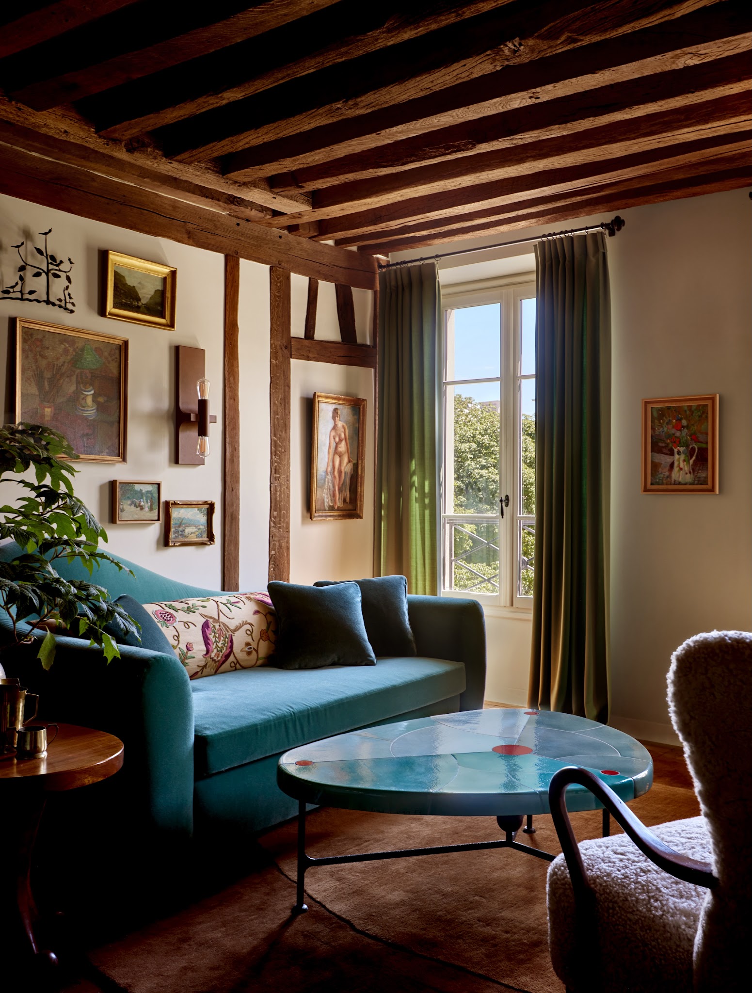 20. Pair Teal Seating with Exposed Beams