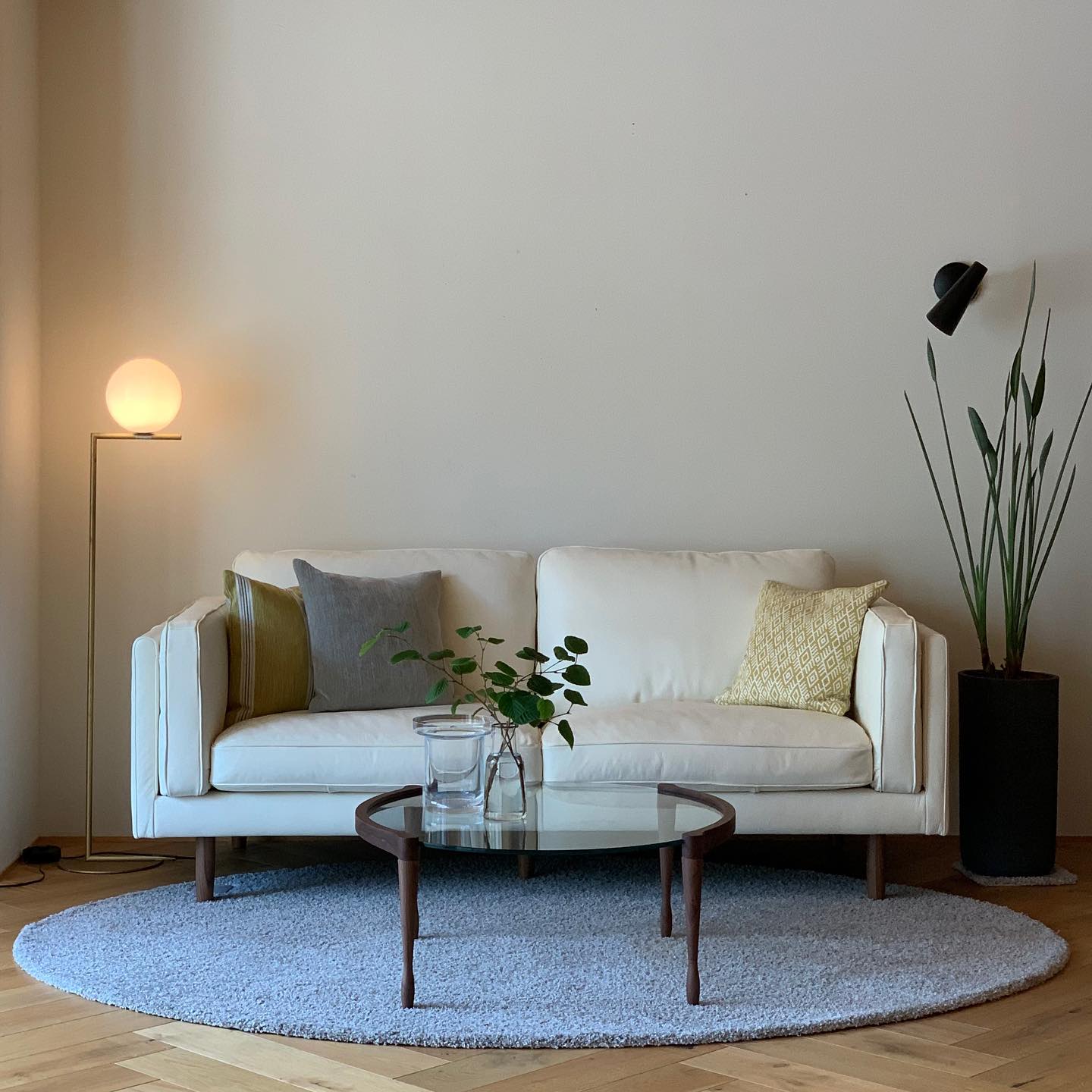 3. Shape a Cream Sofa Corner With a Round Rug