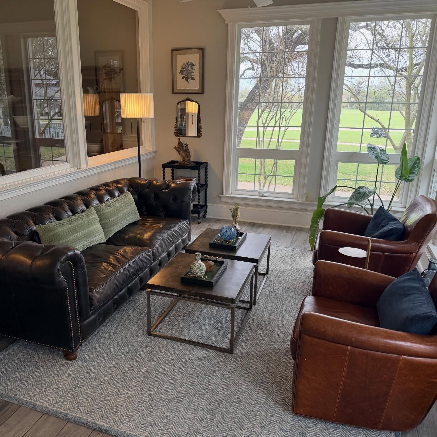 20. Face a Black Chesterfield With Warm Brown Chairs