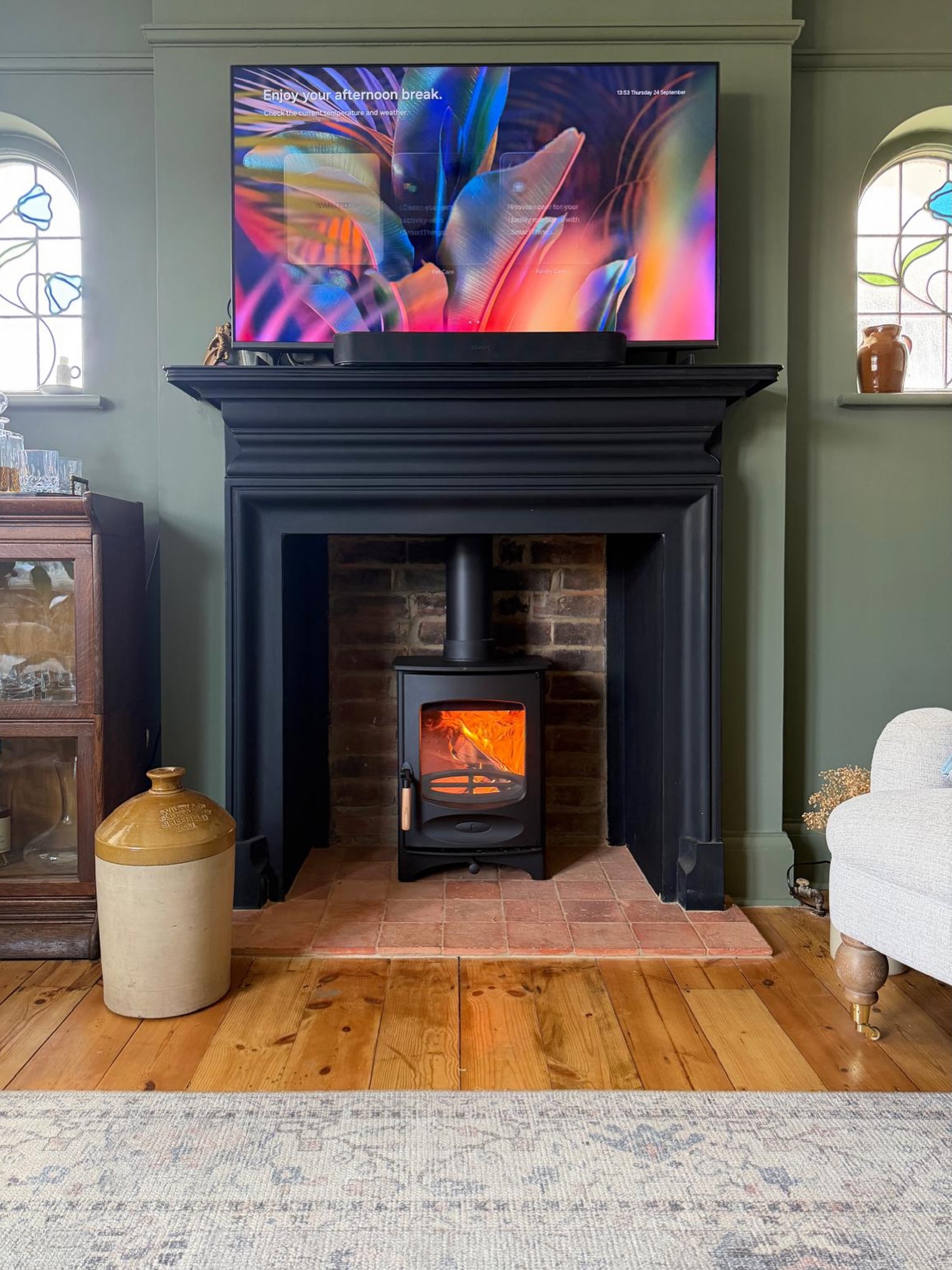 19. Set a Black Mantel Against Muted Green