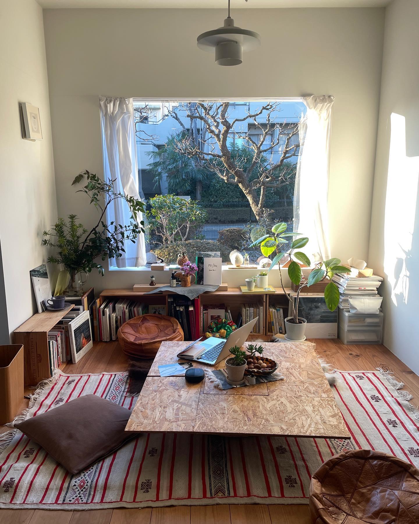 12. Surround a Low Table With Leather Poufs and Books