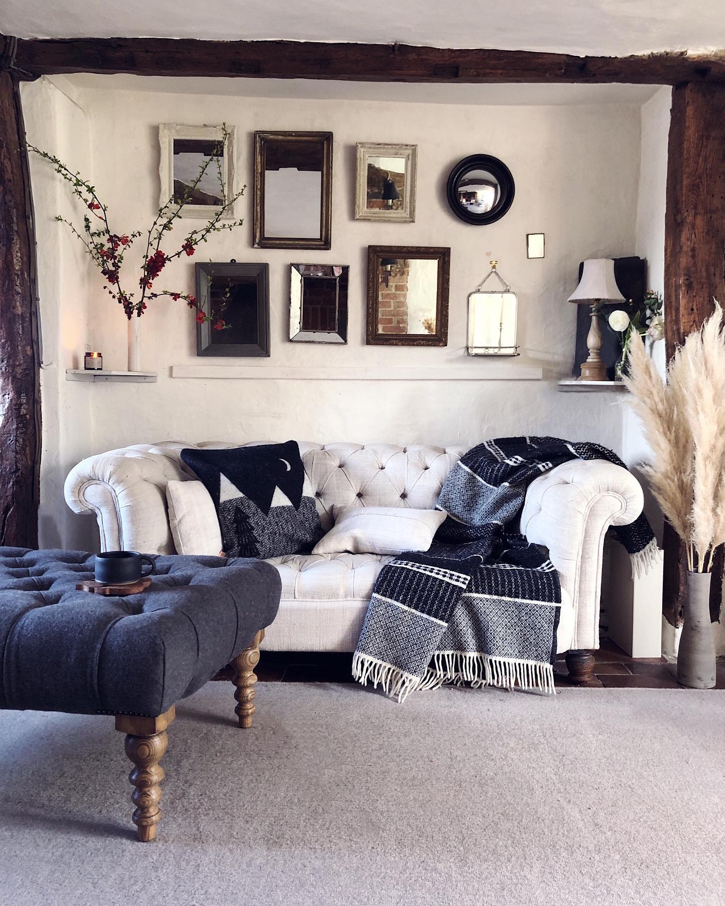14. Build a Mirror Gallery Above a Tufted Sofa