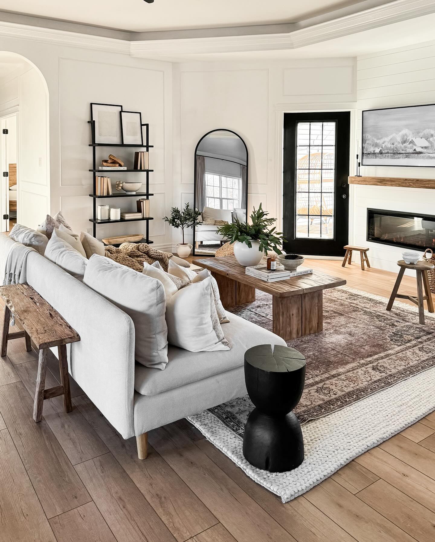 2. Soften Wall Paneling with an Arched Mirror
