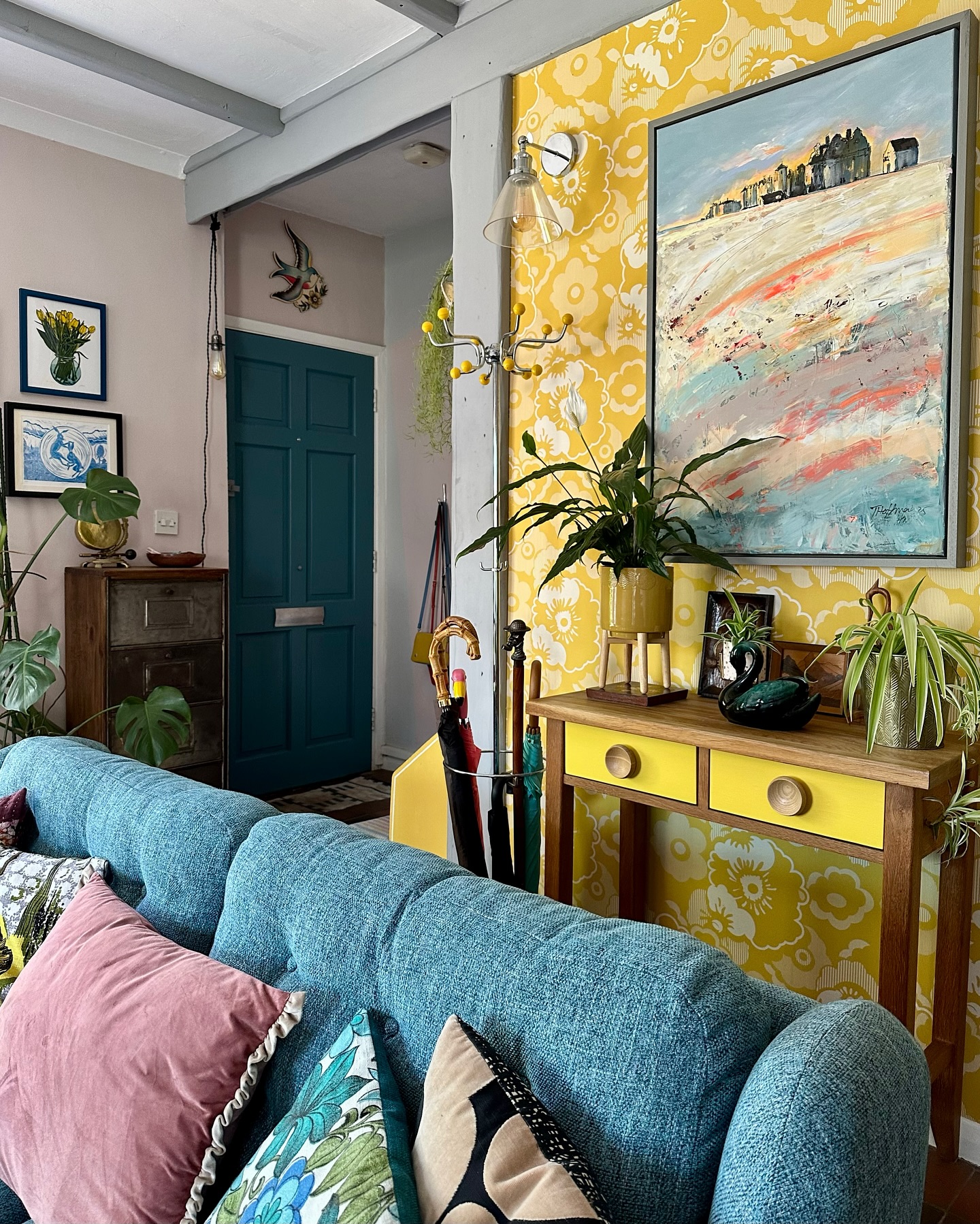 5. Layer a Large Painting Over Patterned Wallpaper
