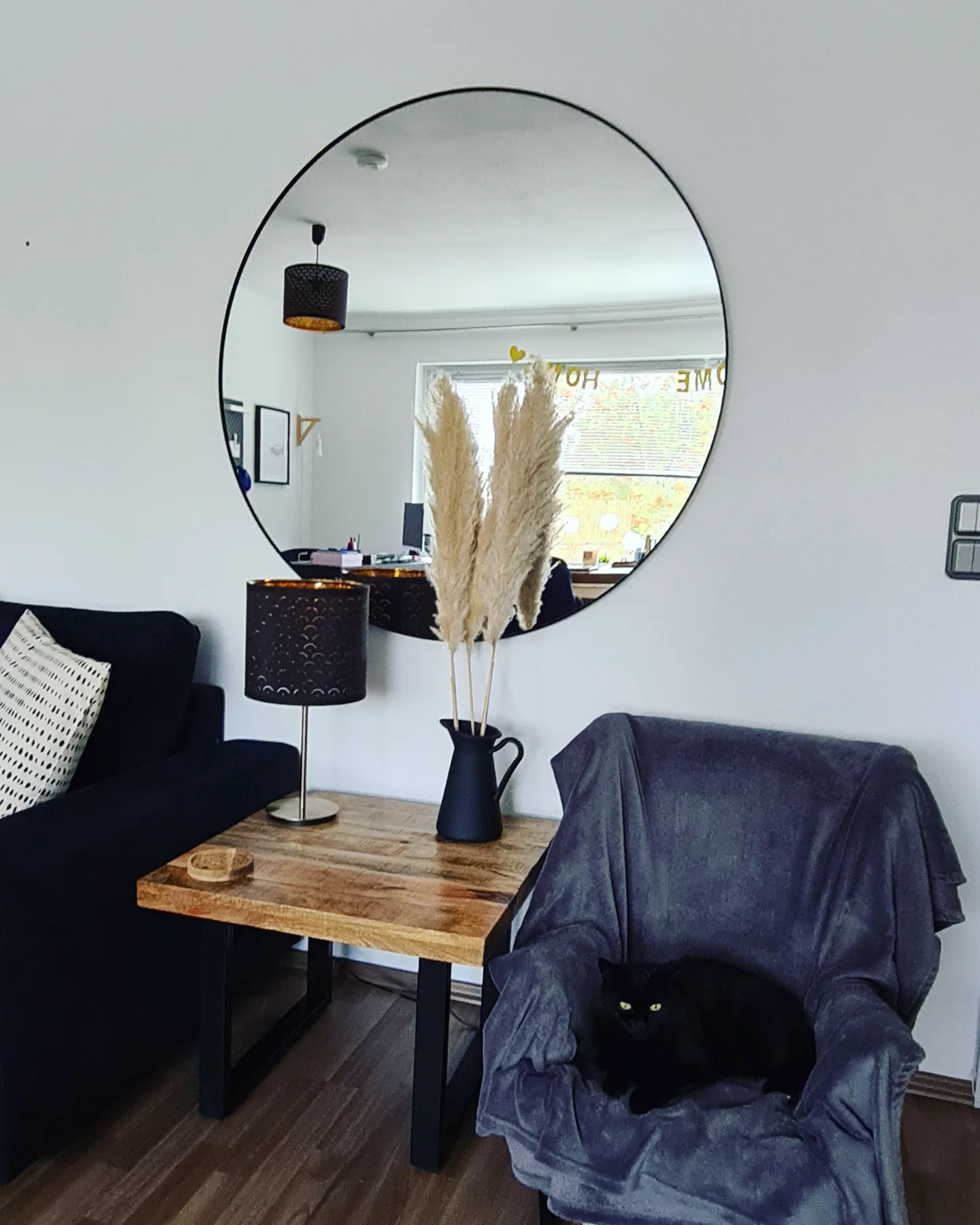 15. Give a Seating Corner One Oversized Round Mirror