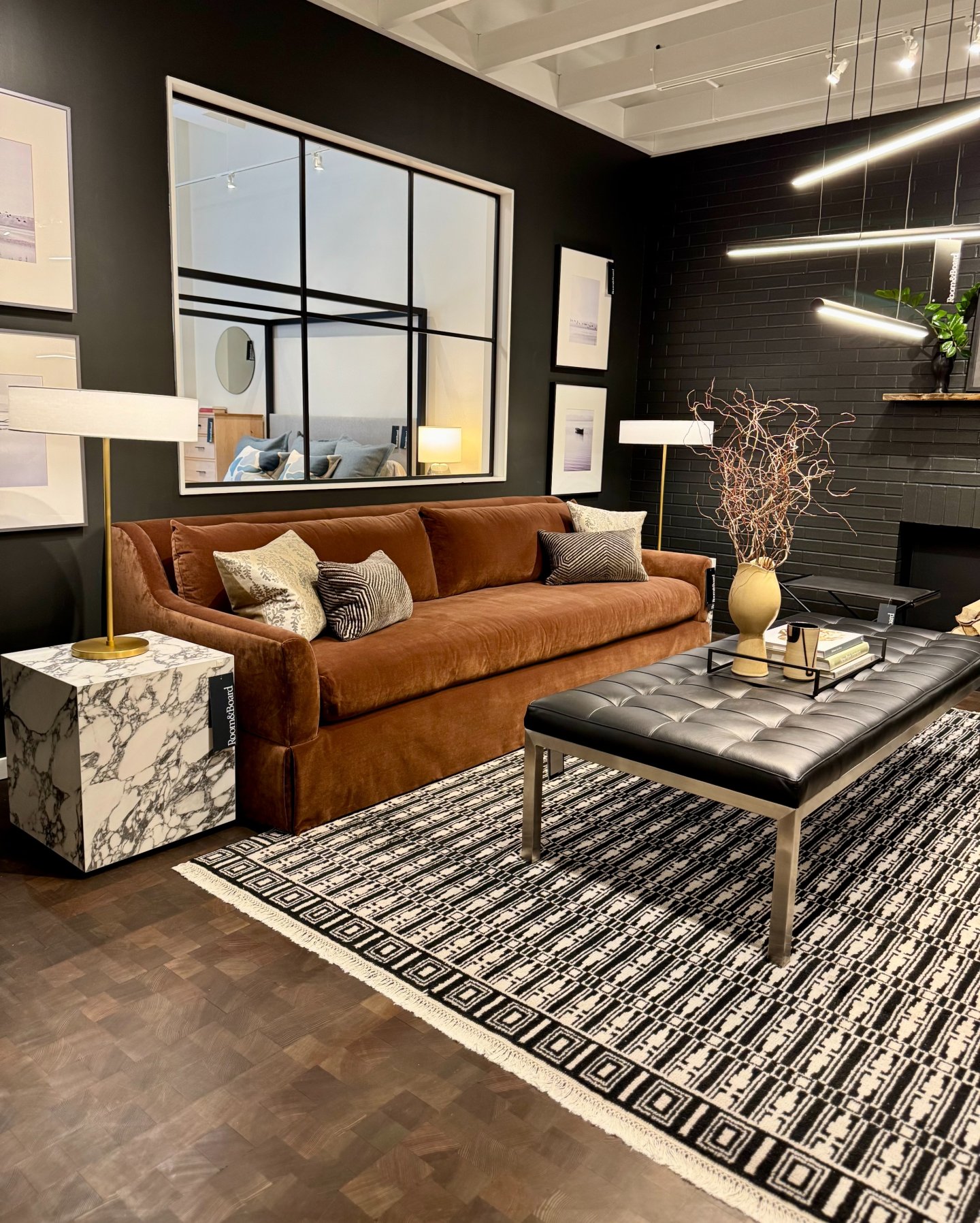 7. Use a Gridded Mirror Above a Warm Brown Sofa