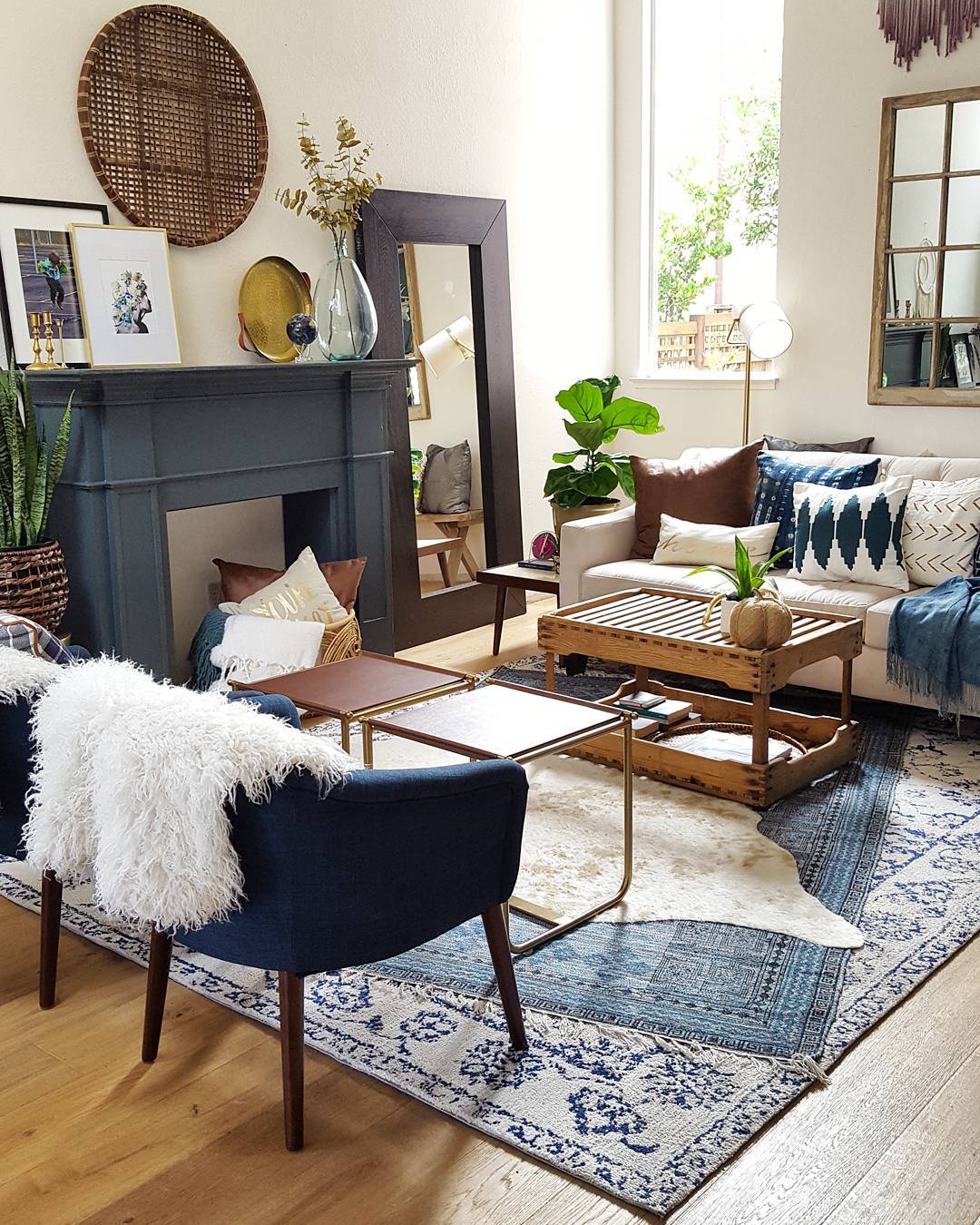 3. Layer Blue and Cream Rugs Beneath Simple Seating
