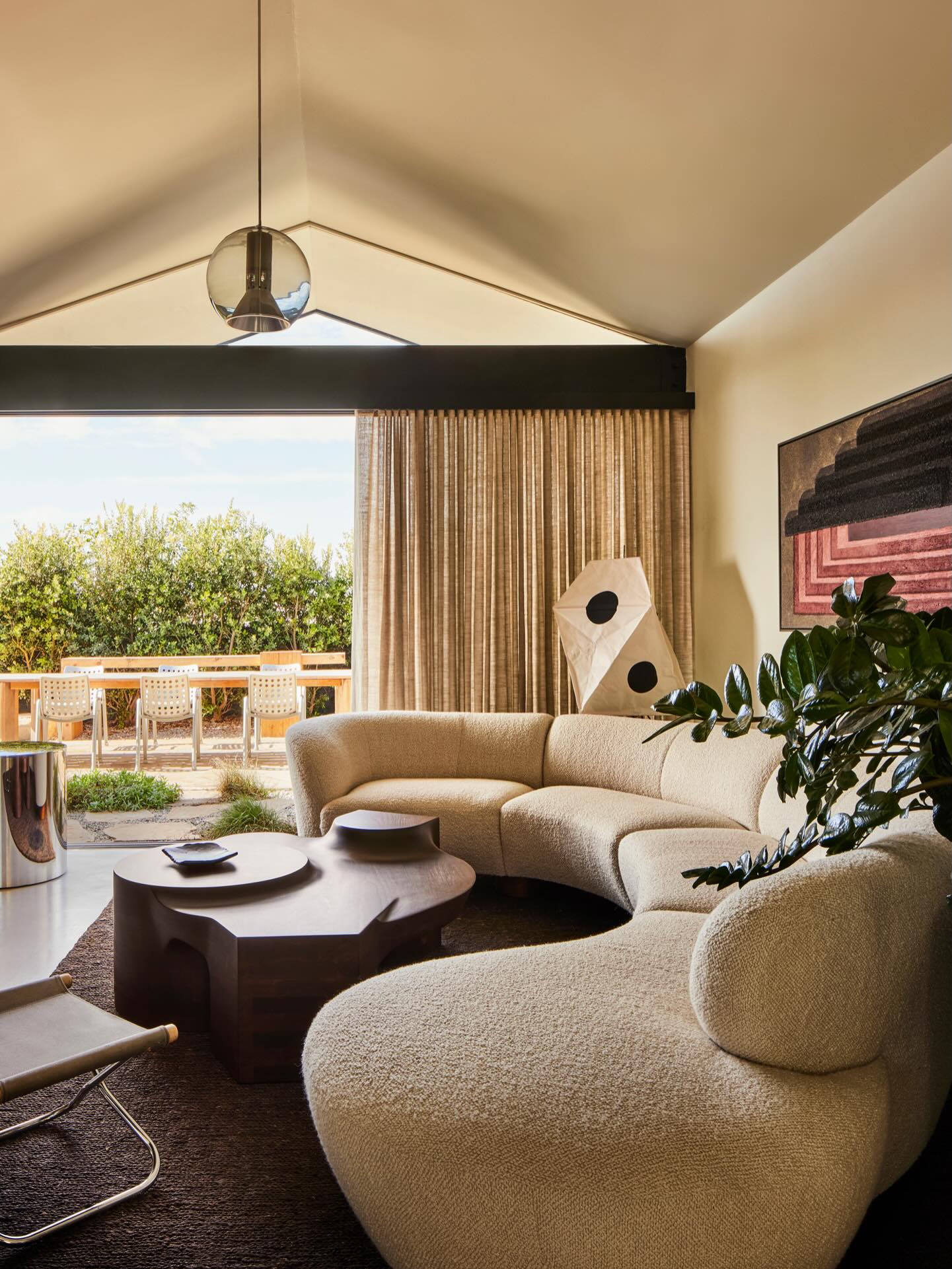 9. Pair a Curved Sofa with a Sculptural Table