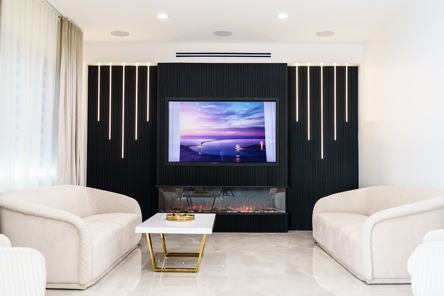 14. Soften a Black Media Wall With Curved White Seating
