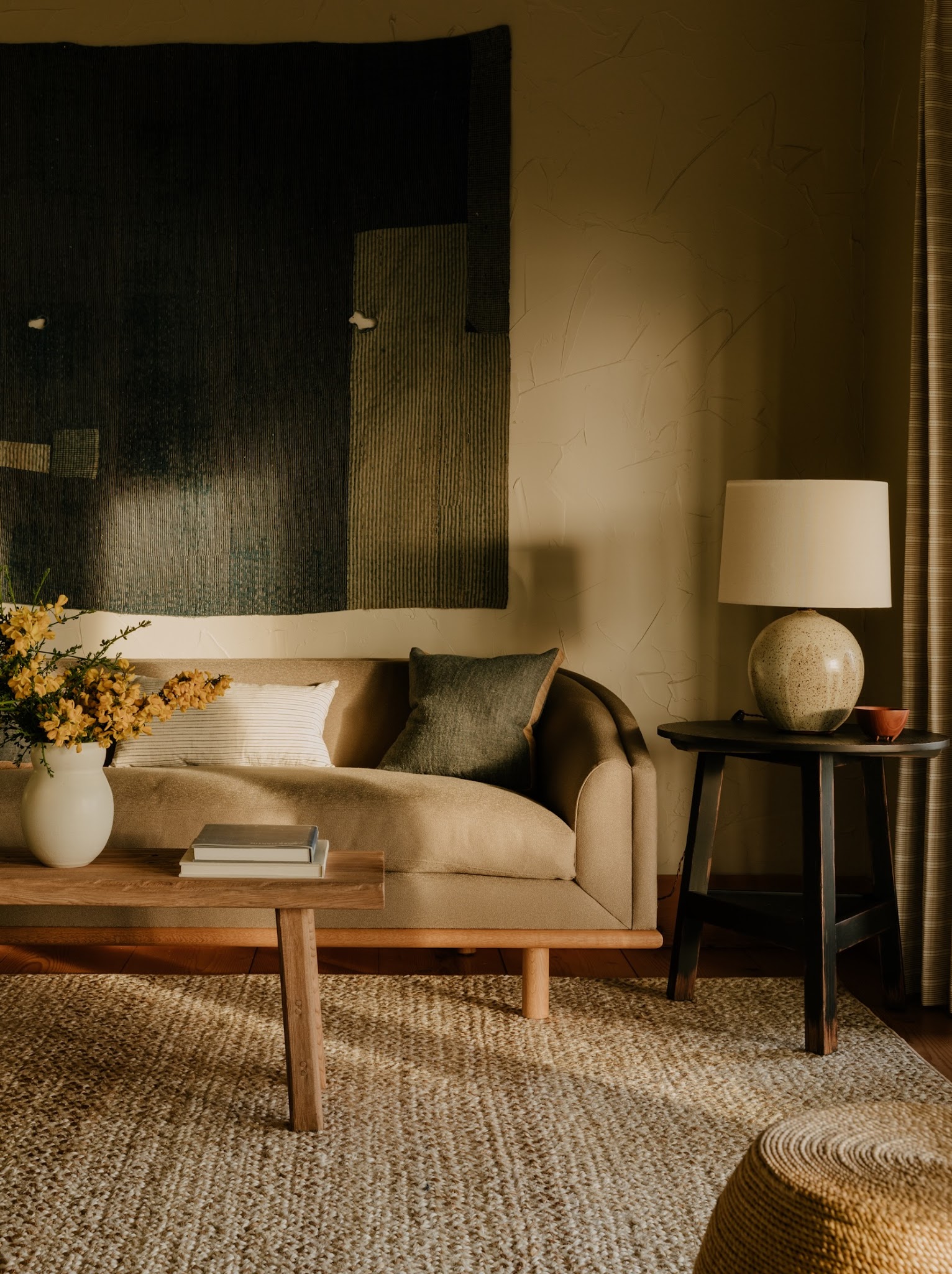 12. Give a Warm Neutral Sofa a Dark Textile Backdrop