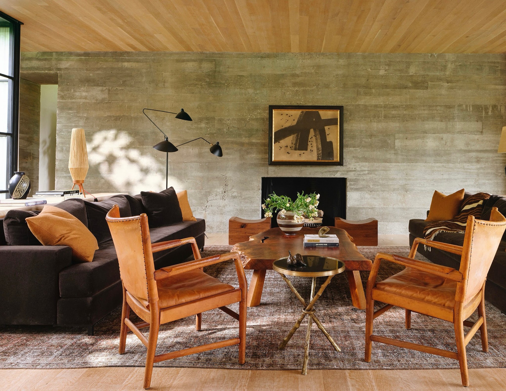 17. Pair Cognac Leather With a Concrete Fireplace Wall
