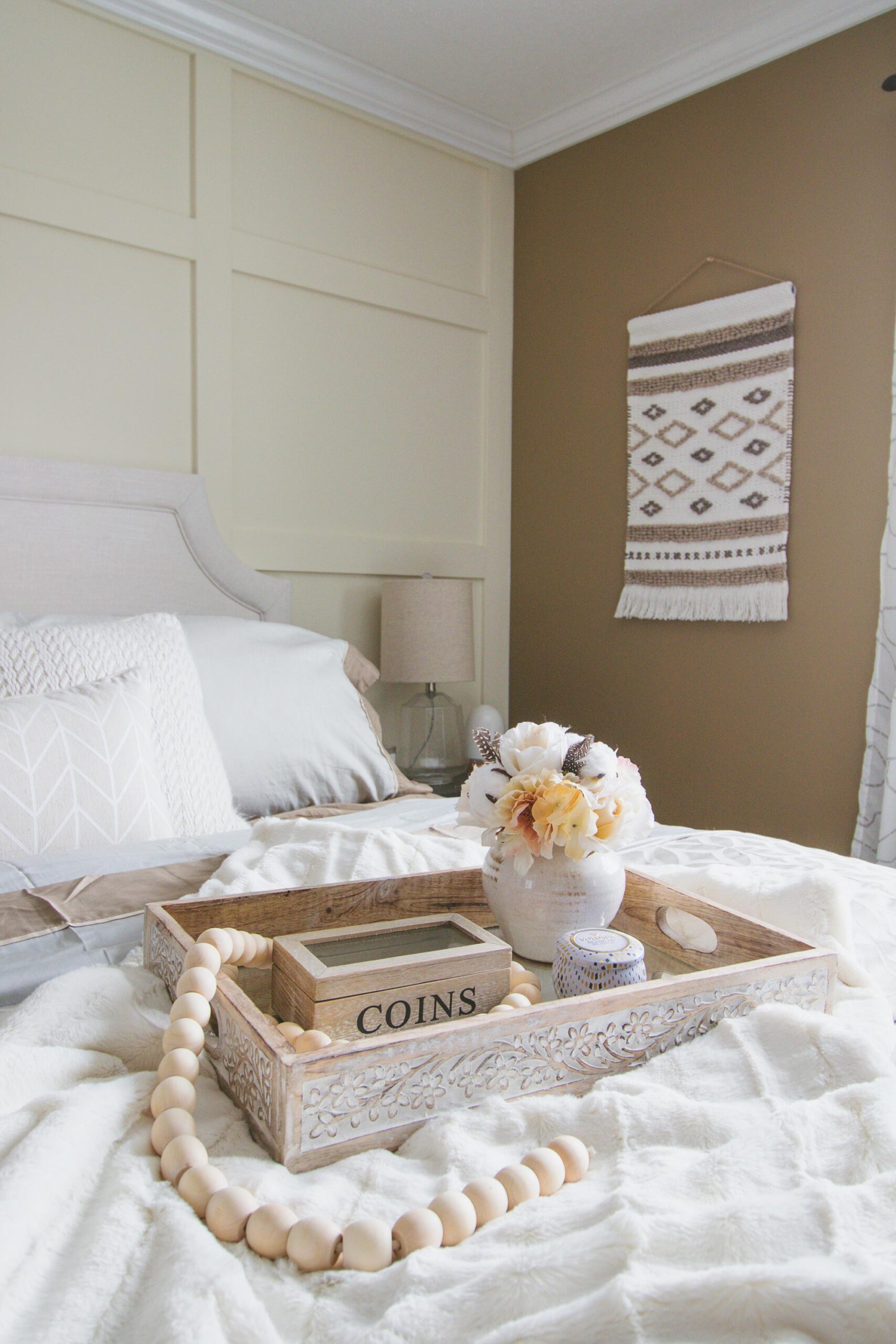 12. Hang a Neutral Textile Beside the Bed