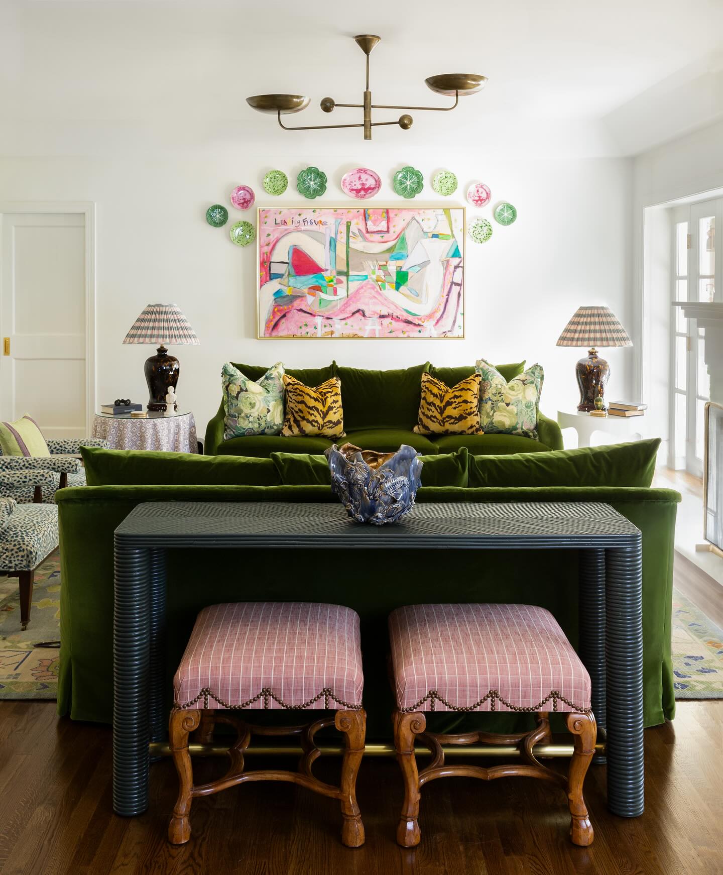 8. Tuck Pink Stools Behind a Green Sofa