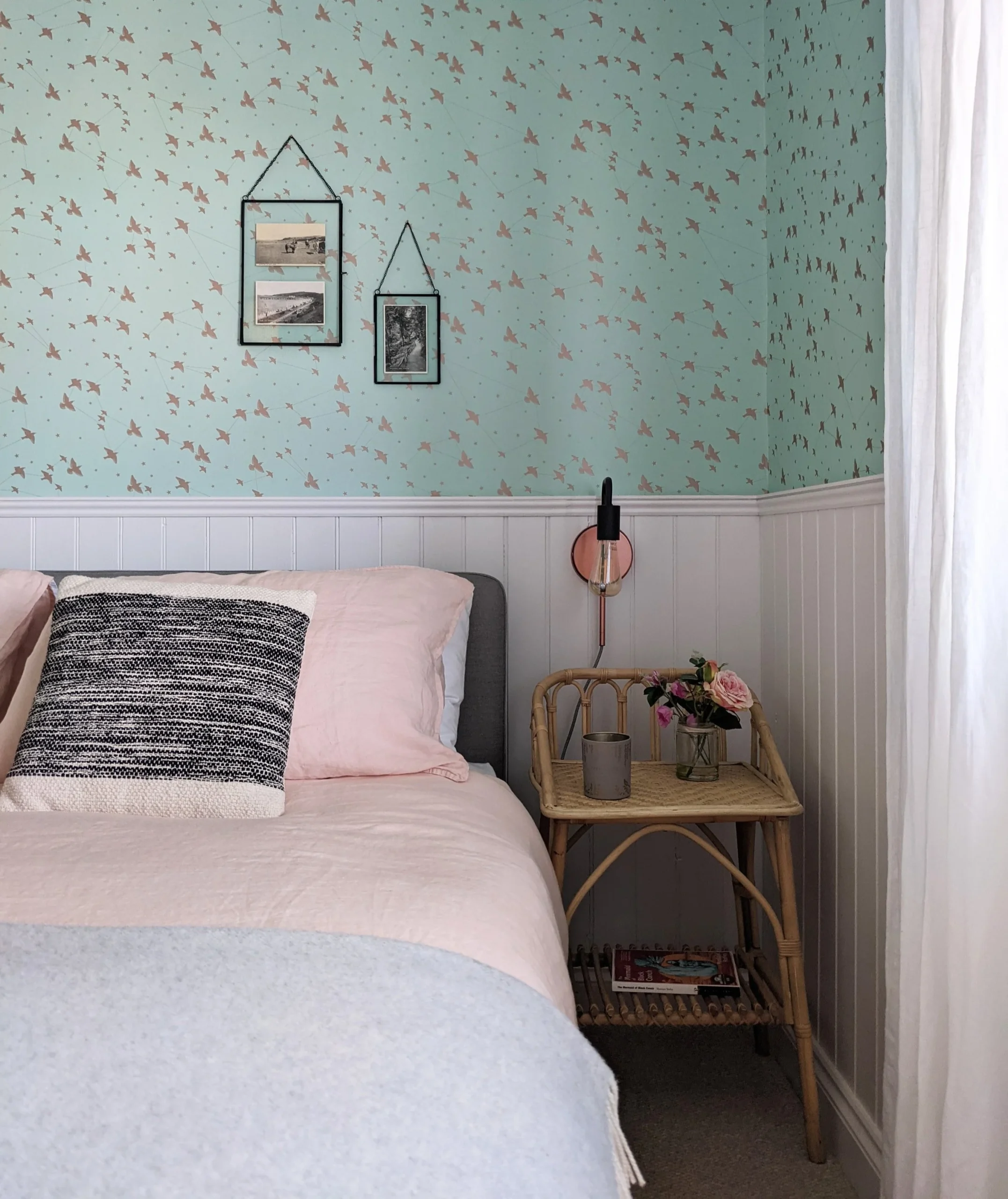 6. Hang Coastal Postcards Above Blush Bedding