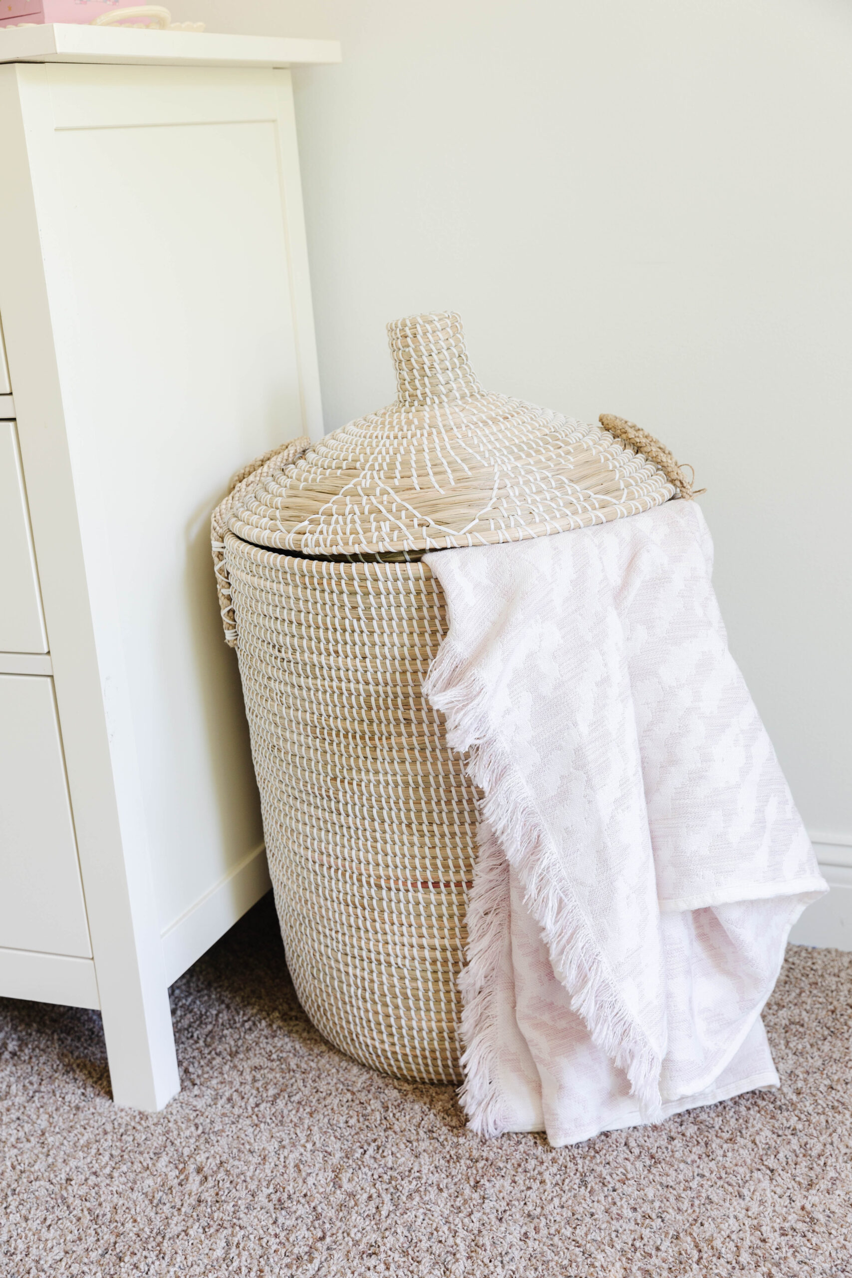 14. Soften a Woven Hamper With a Blush Throw