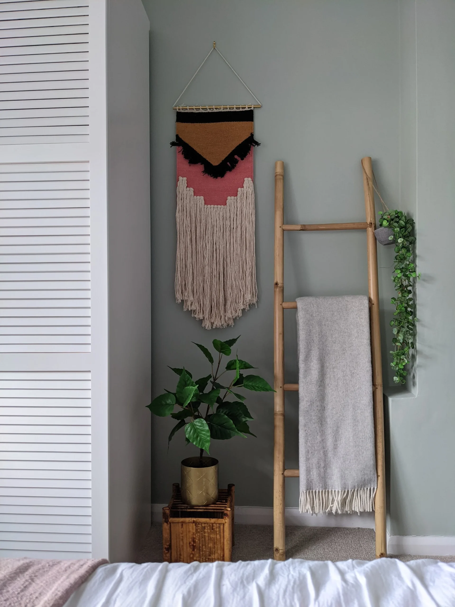 16. Add a Coral Wall Hanging and a Bamboo Blanket Ladder