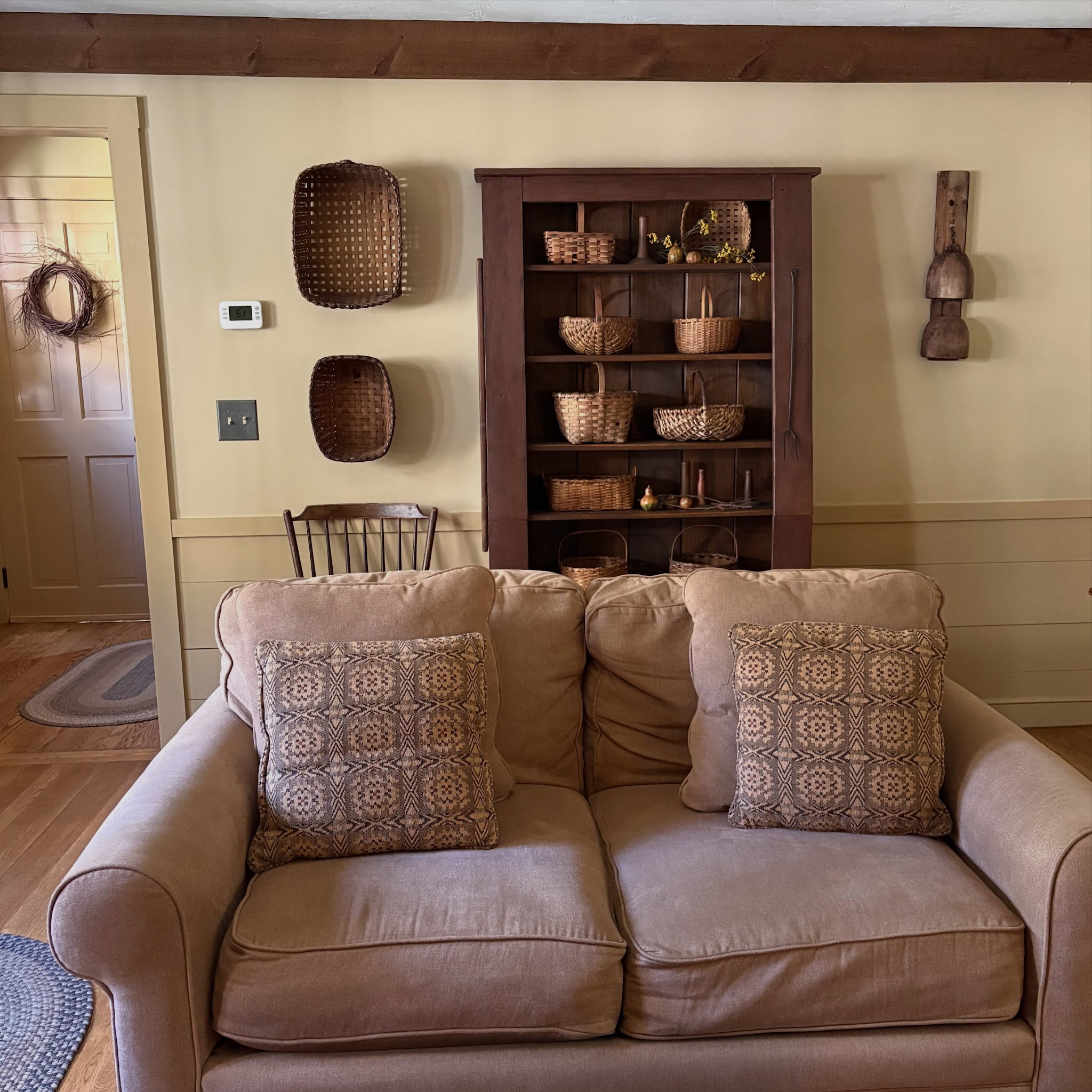 6. Use a Basket Cupboard Behind Simple Seating