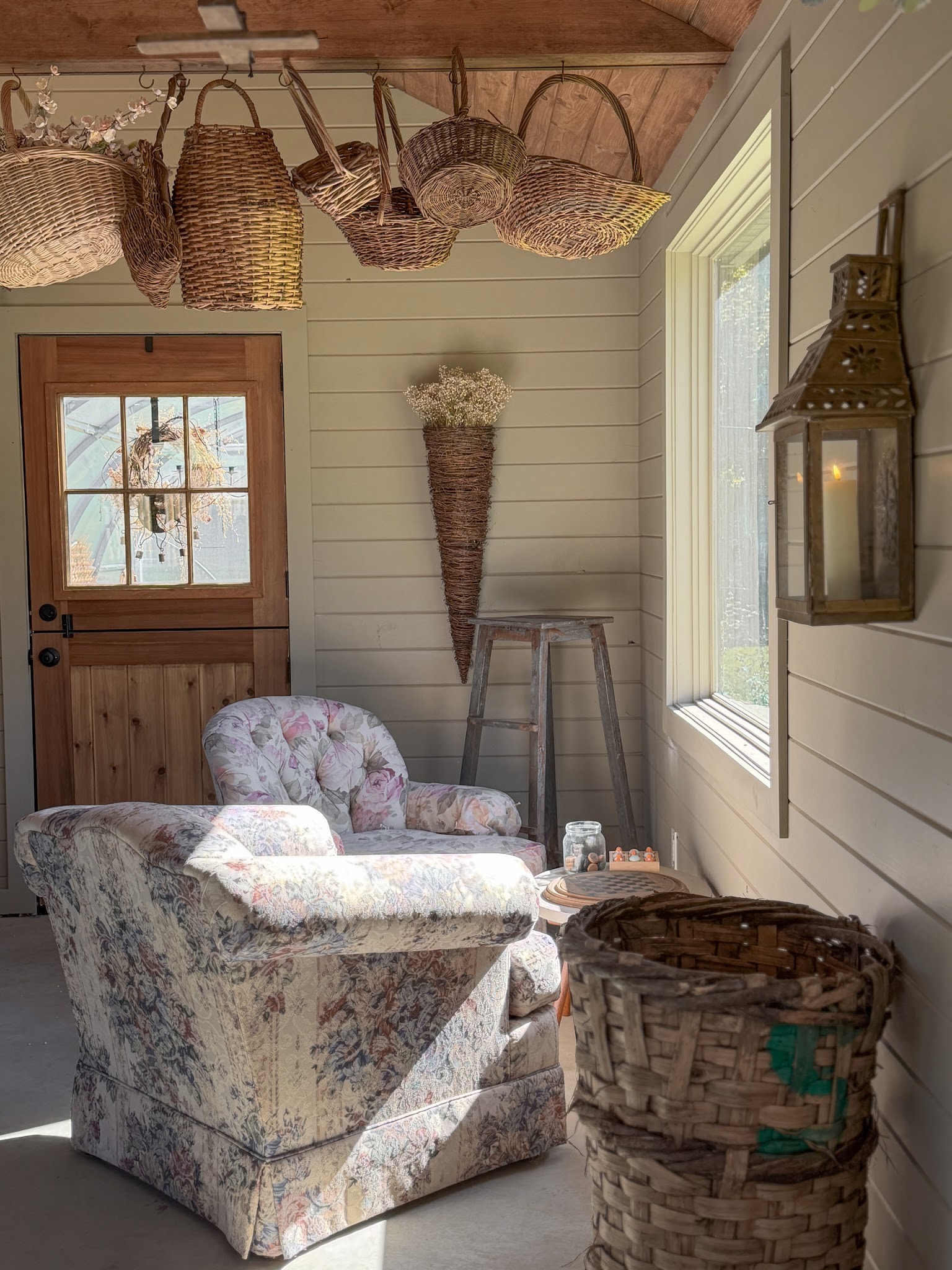 16. Place a Weathered Basket Beside Floral Chairs