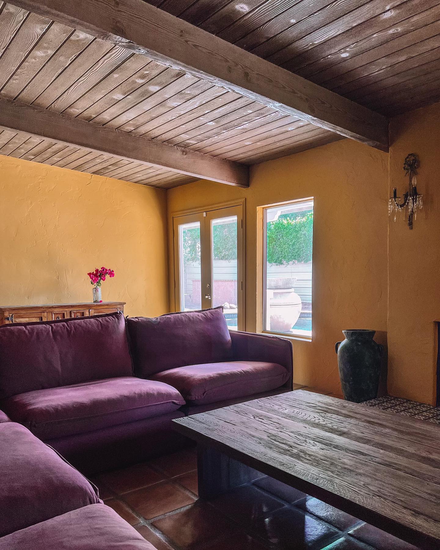9. Warm a Plum Sectional with Ochre Walls