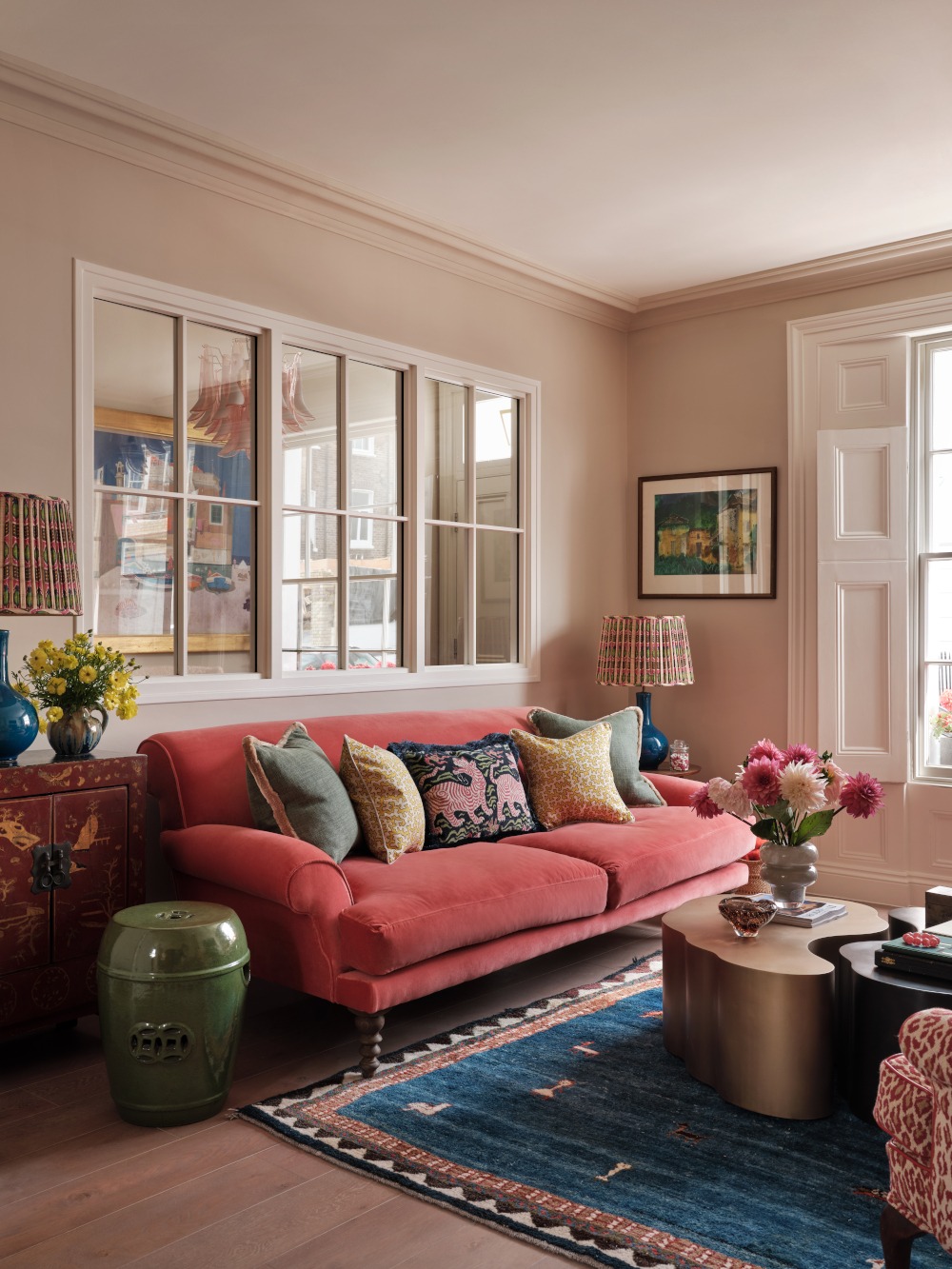 6. Pair a Coral Sofa with a Blue Rug
