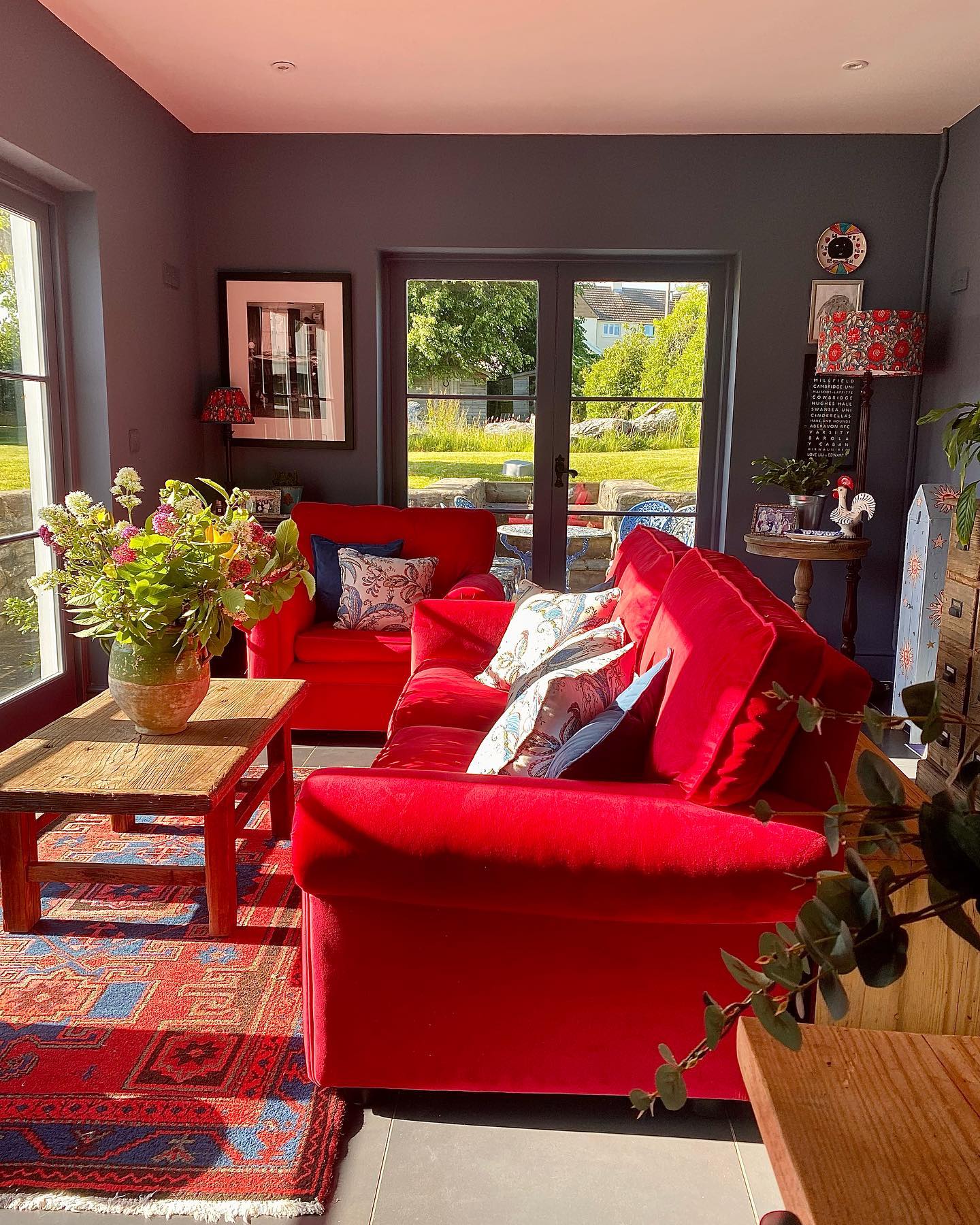 11. Brighten a Garden Room with Red Sofas