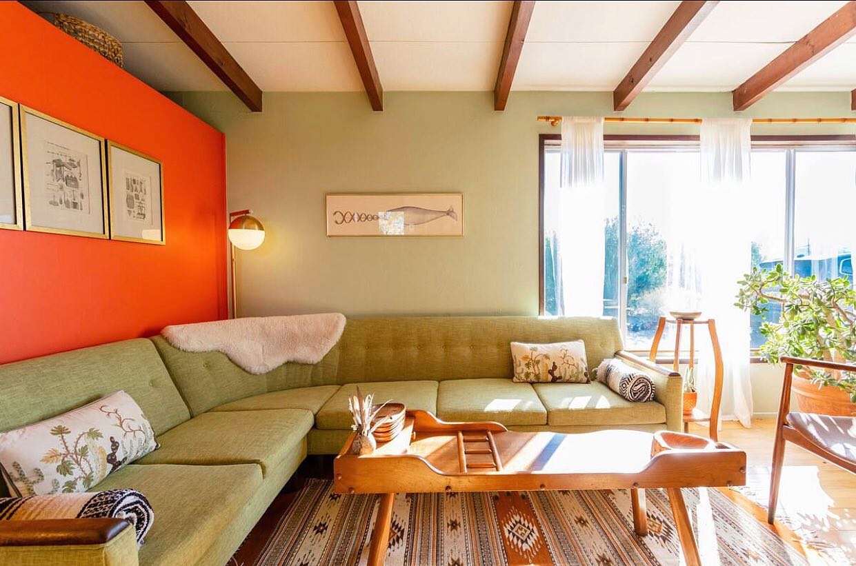 18. Pair Olive Upholstery With a Warm Orange Wall