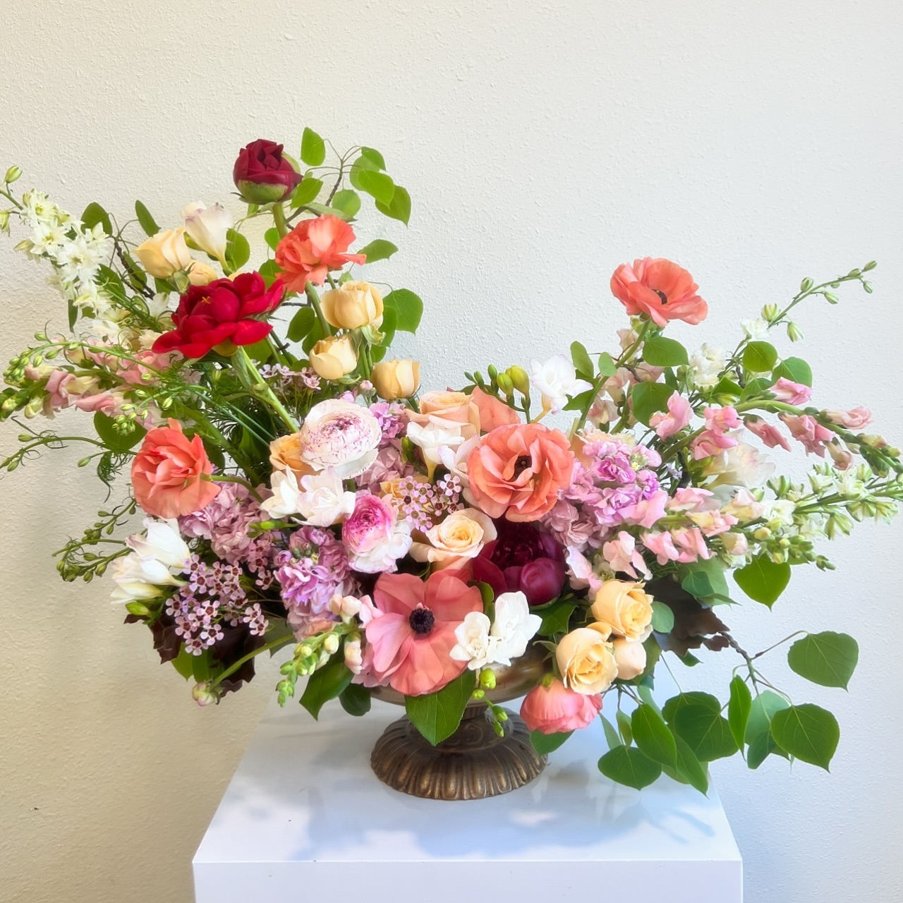 12. Spread Coral and Pink Flowers Beyond a Low Bowl