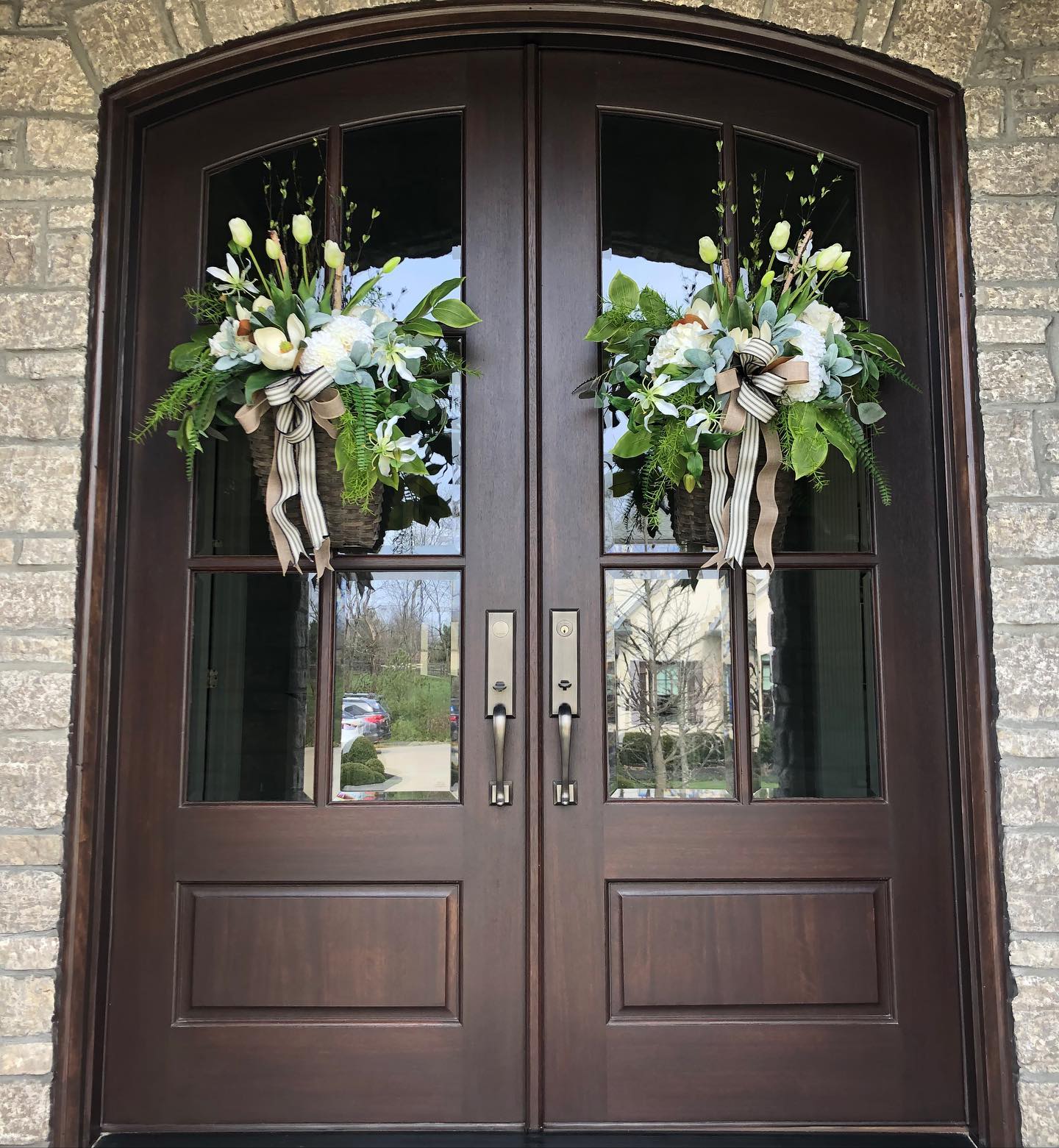 13. Hang Matching White Flower Baskets on Double Doors
