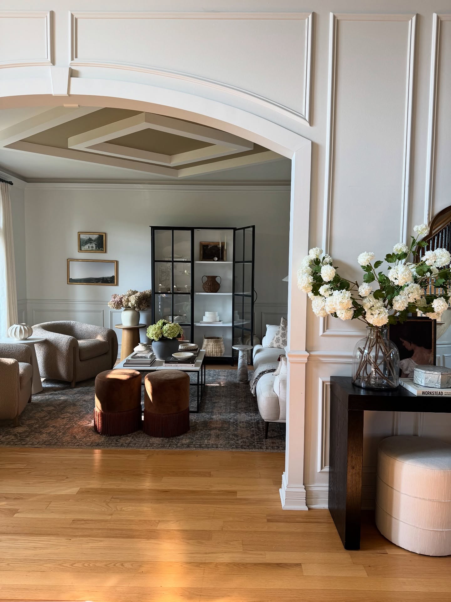 15. Rounded Taupe Chairs Under a Detailed Ceiling