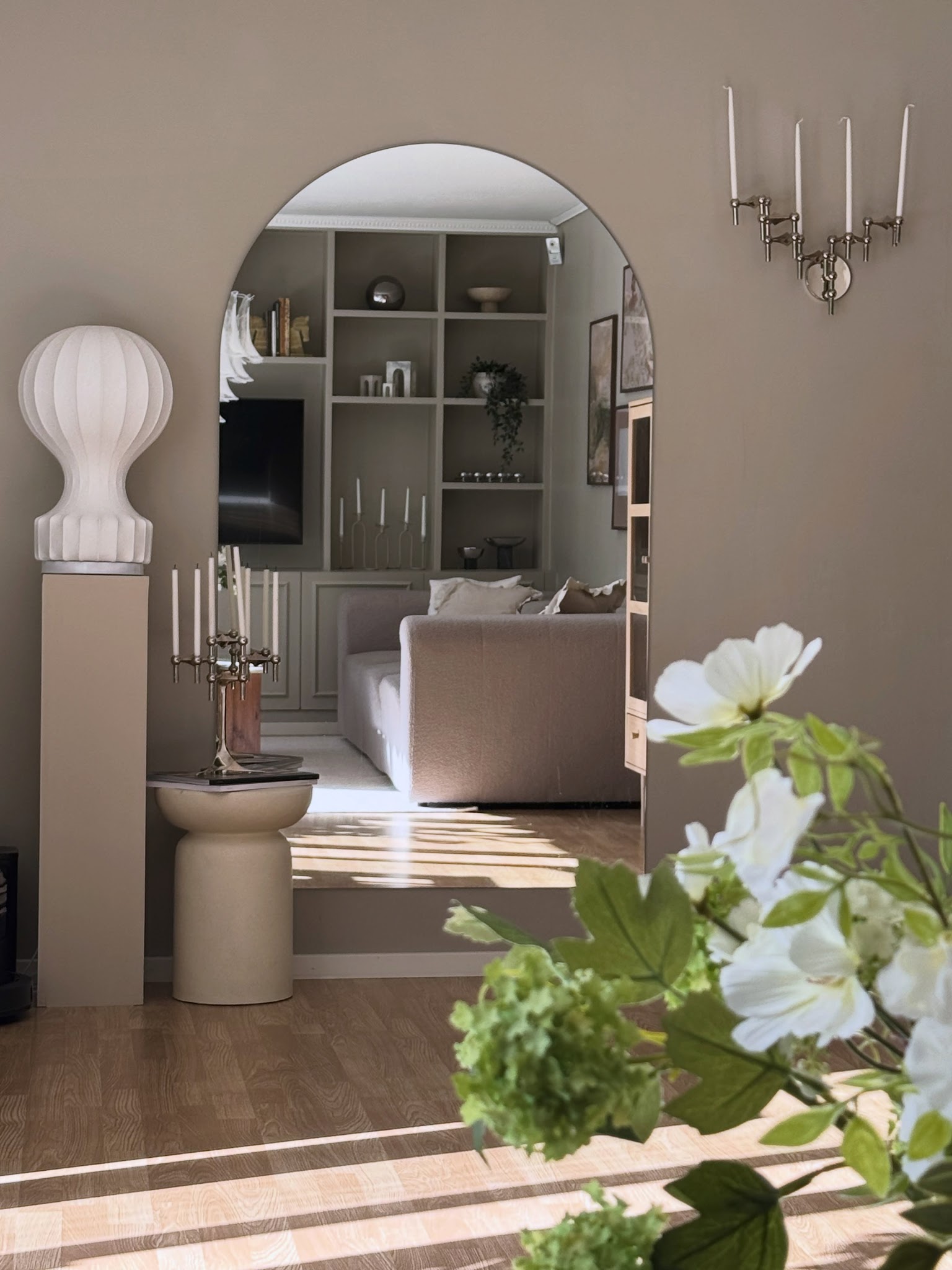 19. An Arched Mirror on a Taupe Wall