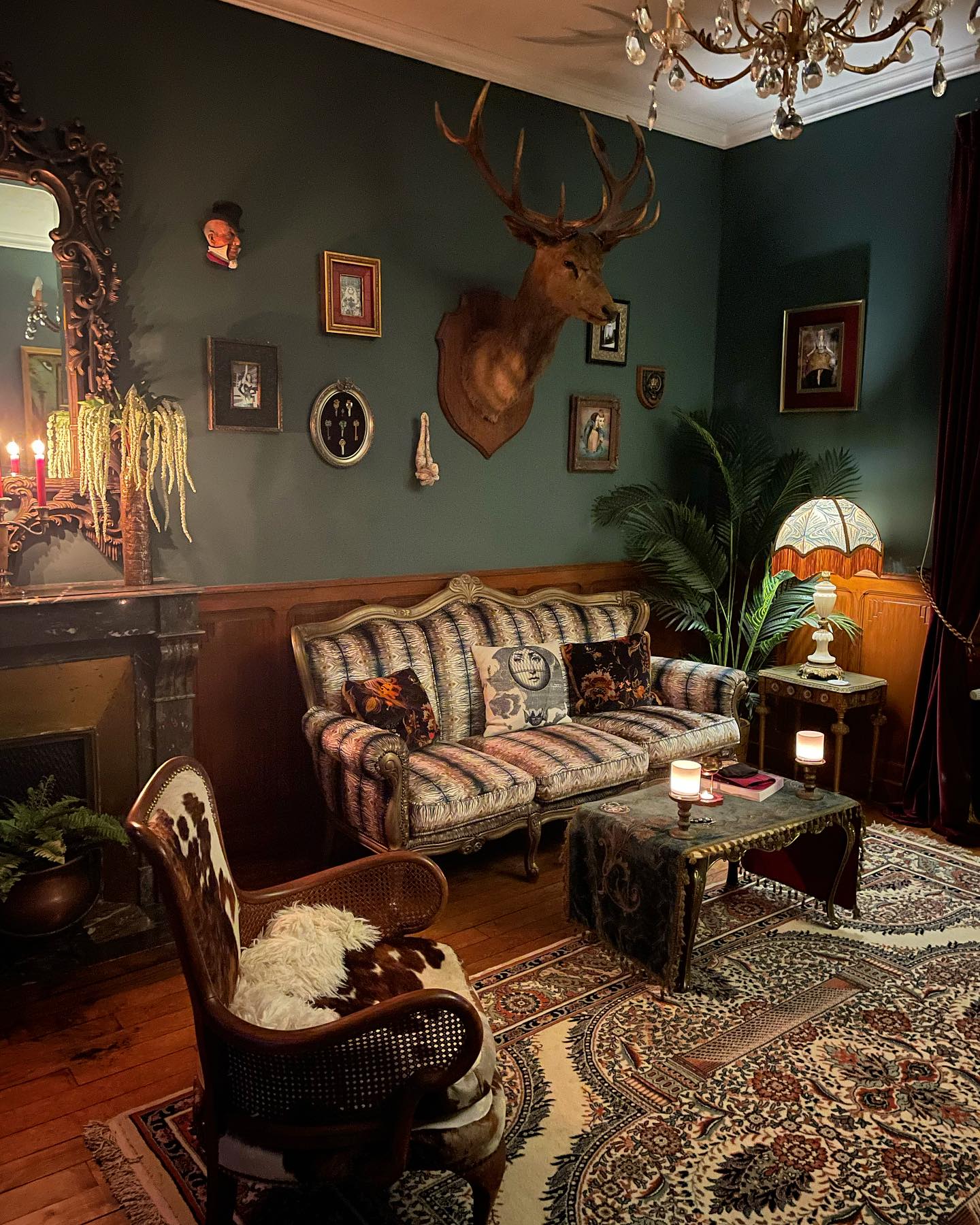 3. Pair Dark Teal With Carved Wood and Warm Light
