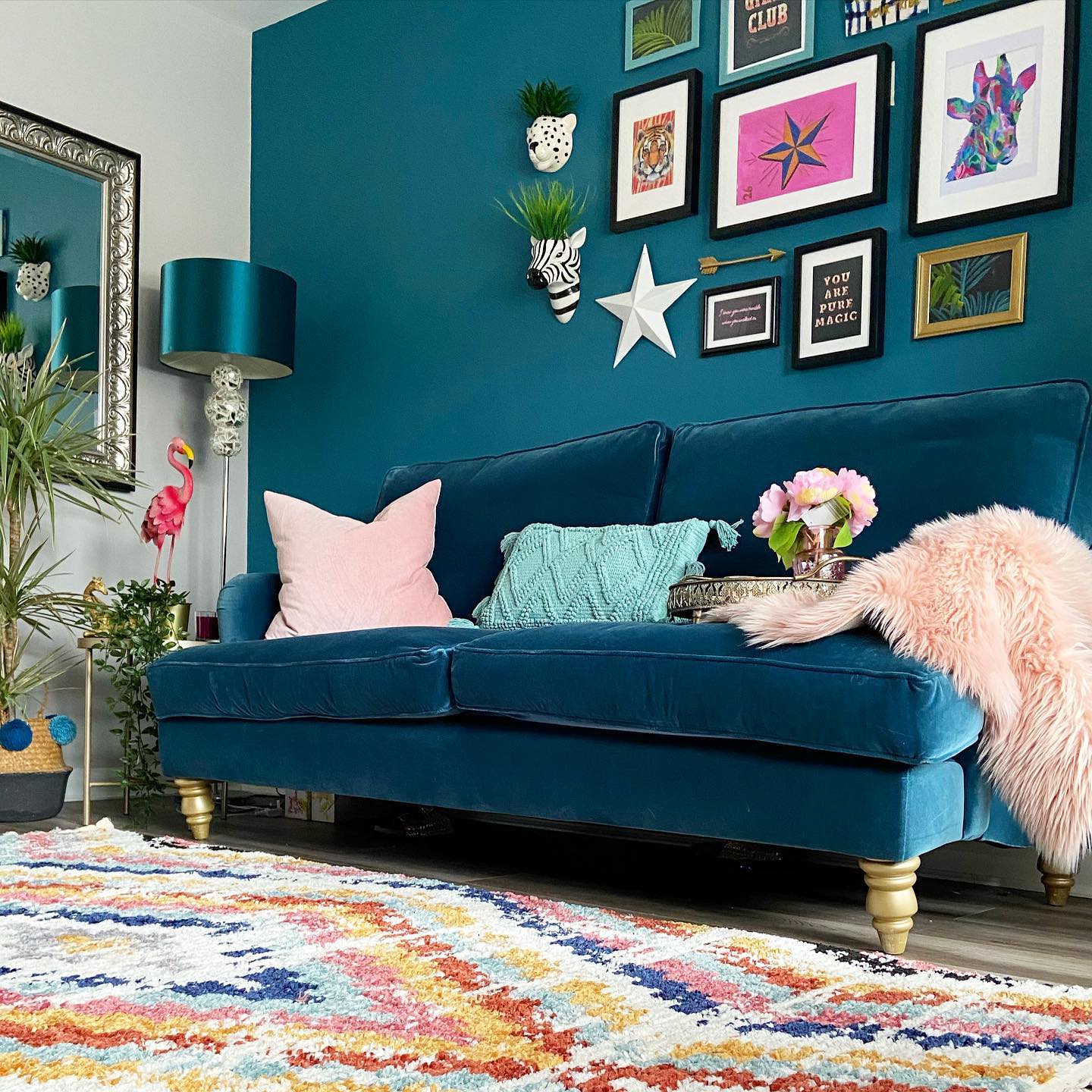 7. Build a Playful Gallery Above a Teal Sofa