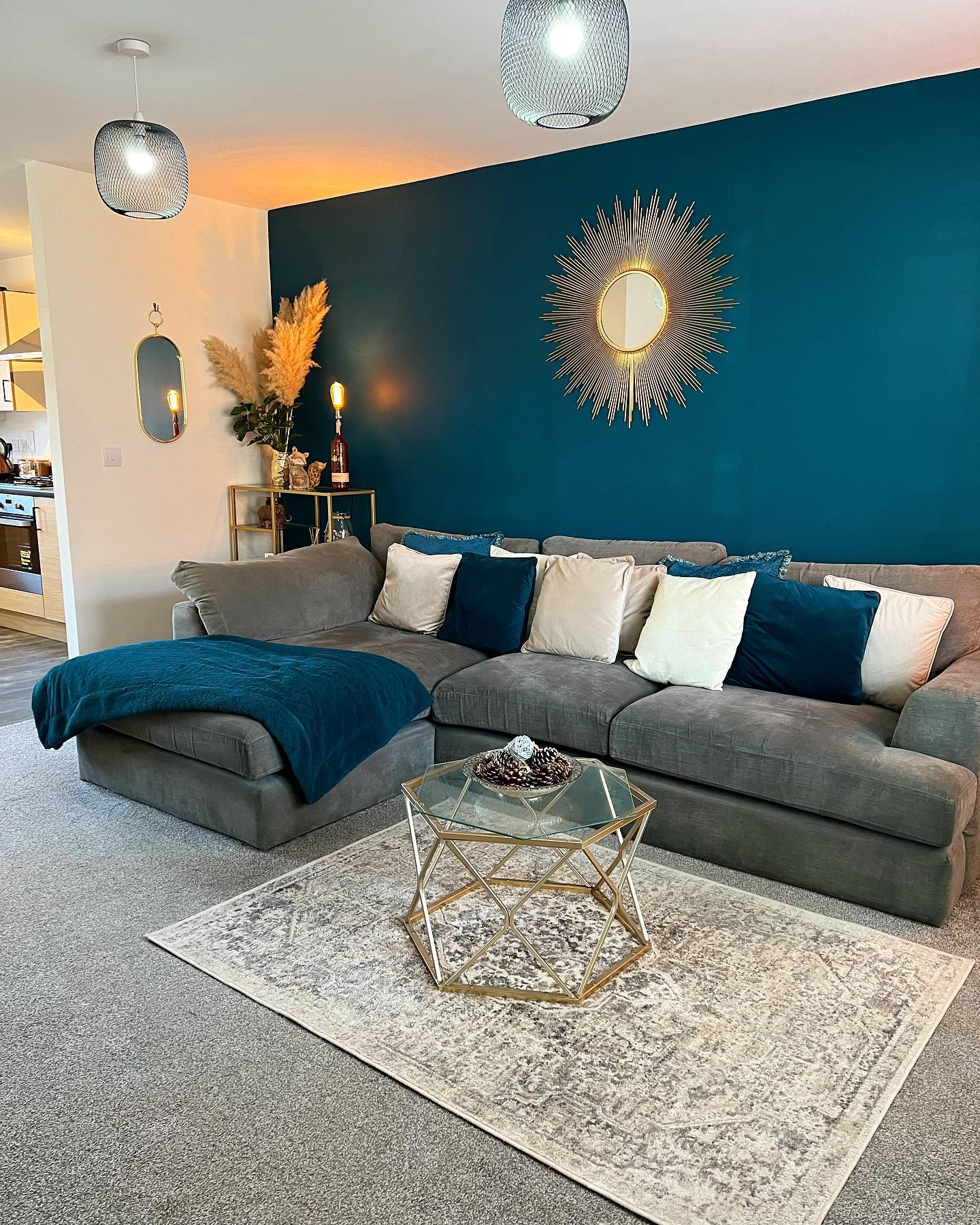 9. Set a Gray Sectional Against a Teal Accent Wall
