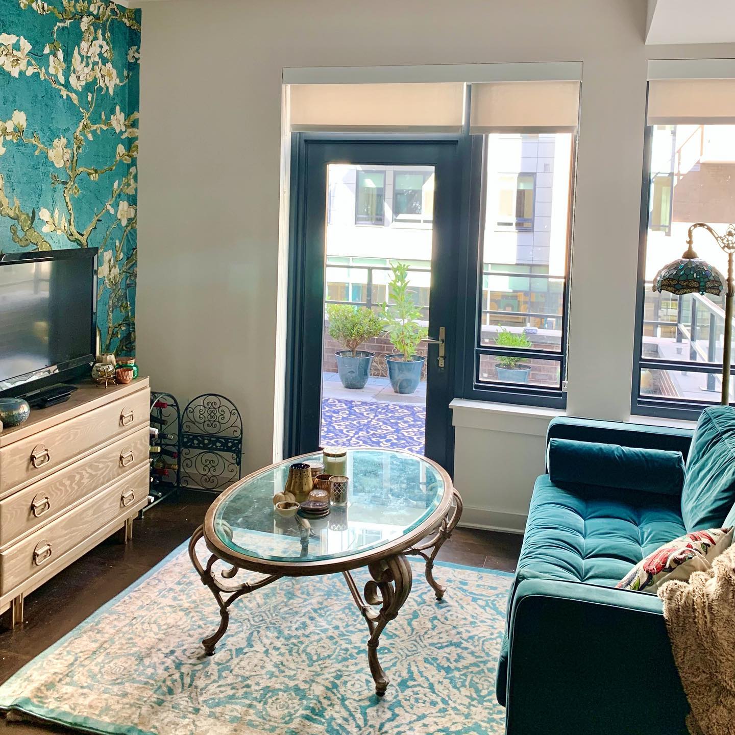 18. Use a Glass Table to Open a Compact Teal Room