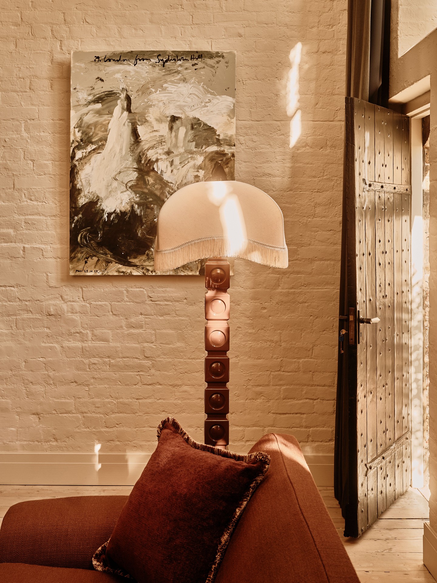 9. Layer a Floor Lamp Behind Rust Seating