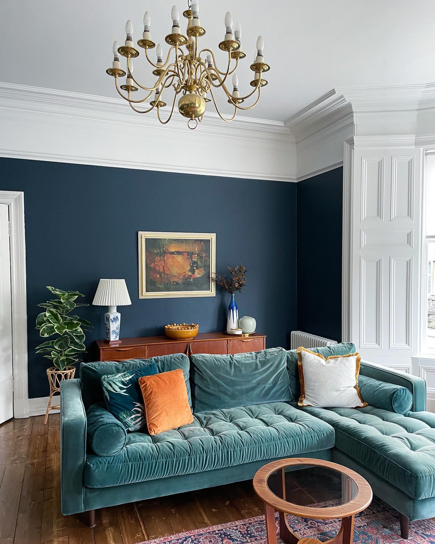 3. Set a Soft Teal Sofa Against Dark Walls