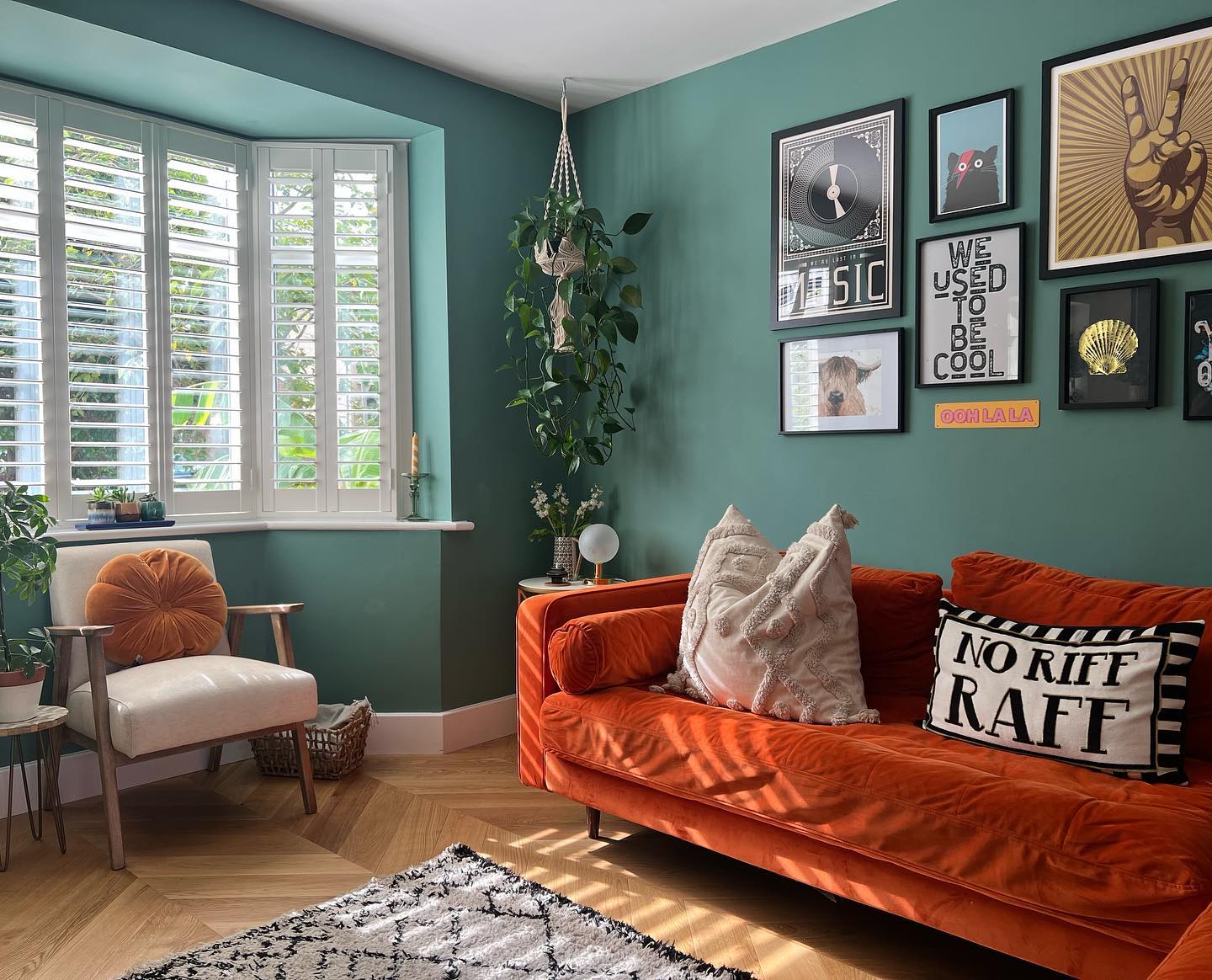 4. Pair Muted Turquoise Walls with an Orange Sofa