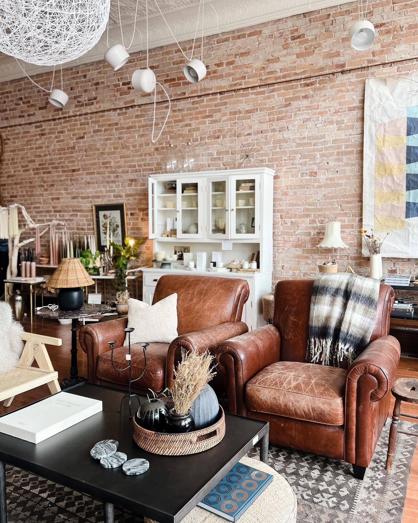 5. Soften Exposed Brick With Leather Lounge Chairs