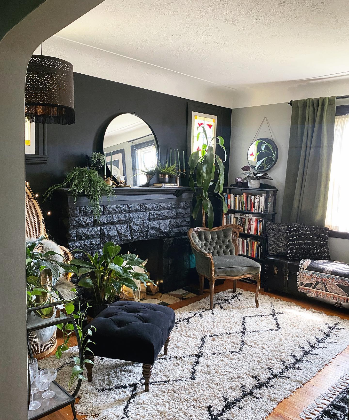 11. Frame a Dark Fireplace With Greenery and Round Mirrors