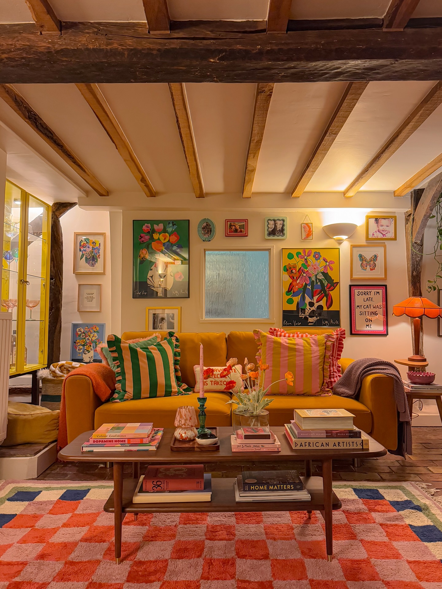 14. A Mustard Sofa Under Exposed Beams